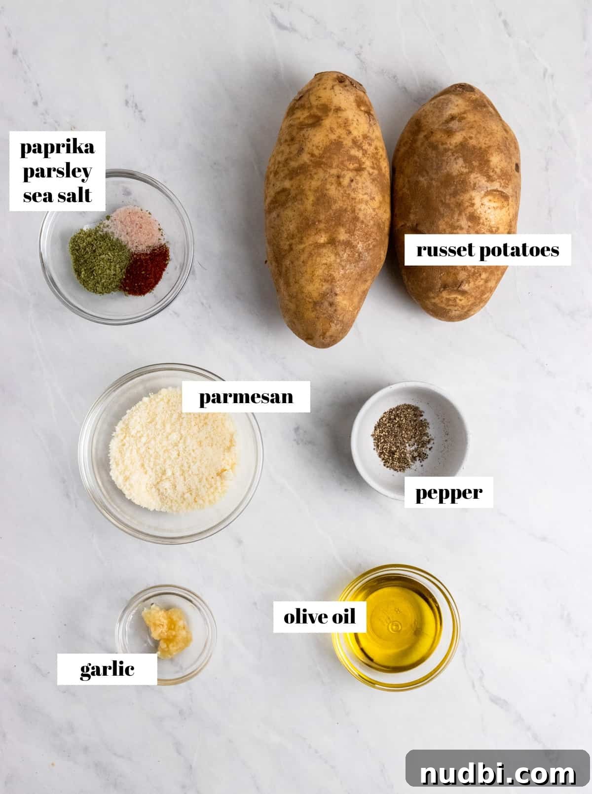 Crispy Air Fryer Potato Wedges Recipe for Perfect Sides 3 Potatoes, olive oil, parmesan and other ingredients labeled on counter.