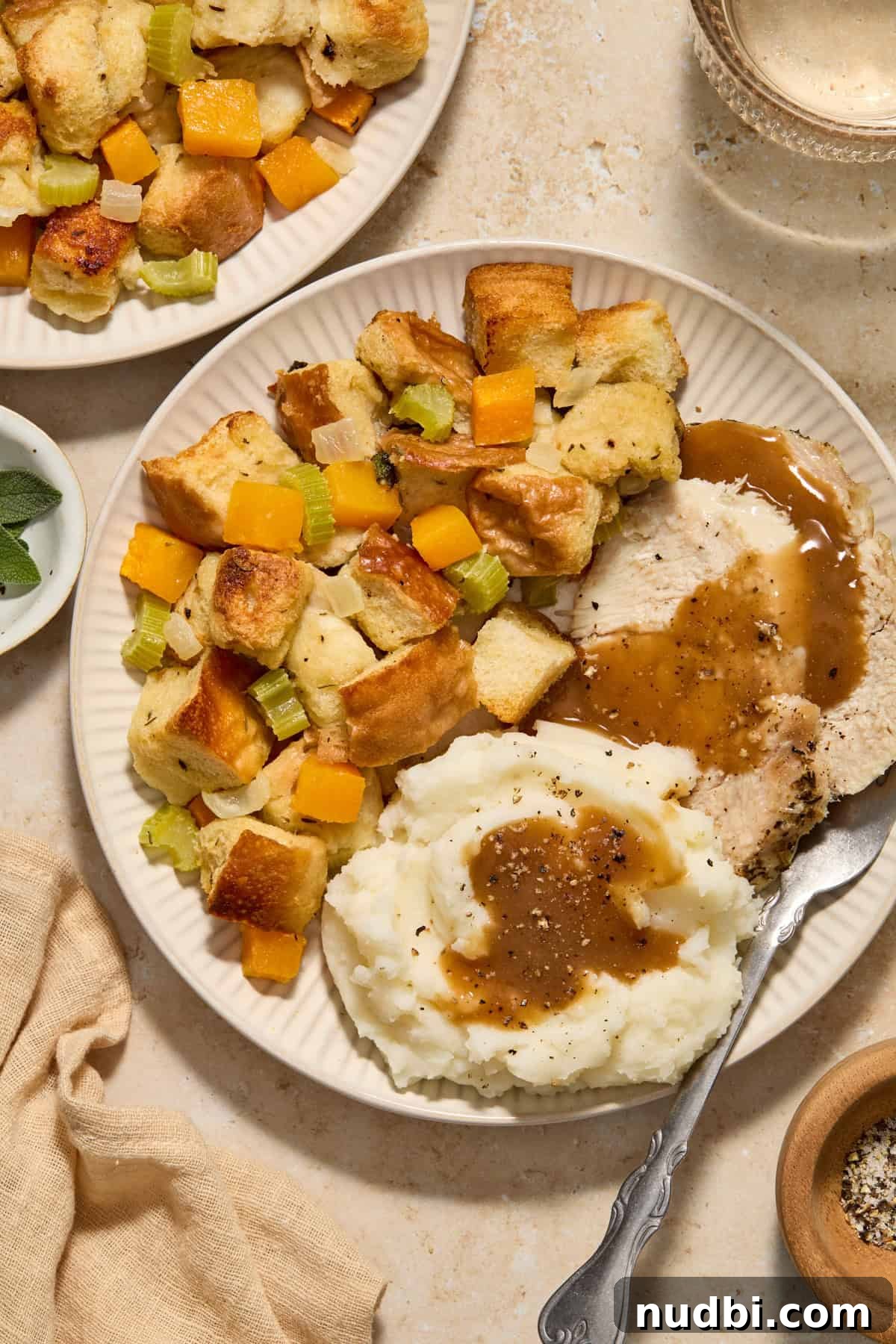 Savory Butternut Squash Stuffing Recipe for Holiday Dinners 2 Butternut squash stuffing on plate with turkey and mashed potatoes.