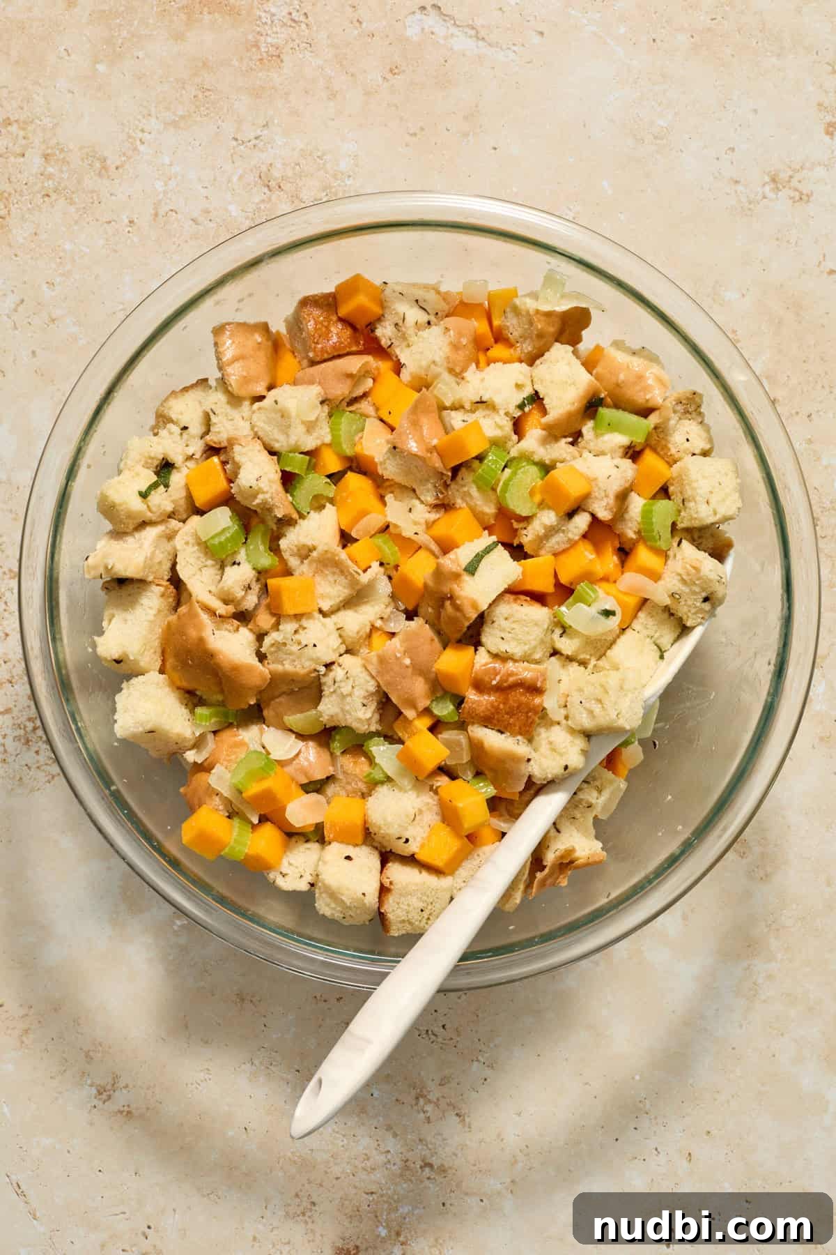 Savory Butternut Squash Stuffing Recipe for Holiday Dinners 7 Prepared dressing mixture in glass bowl before being transferred to baking pan.