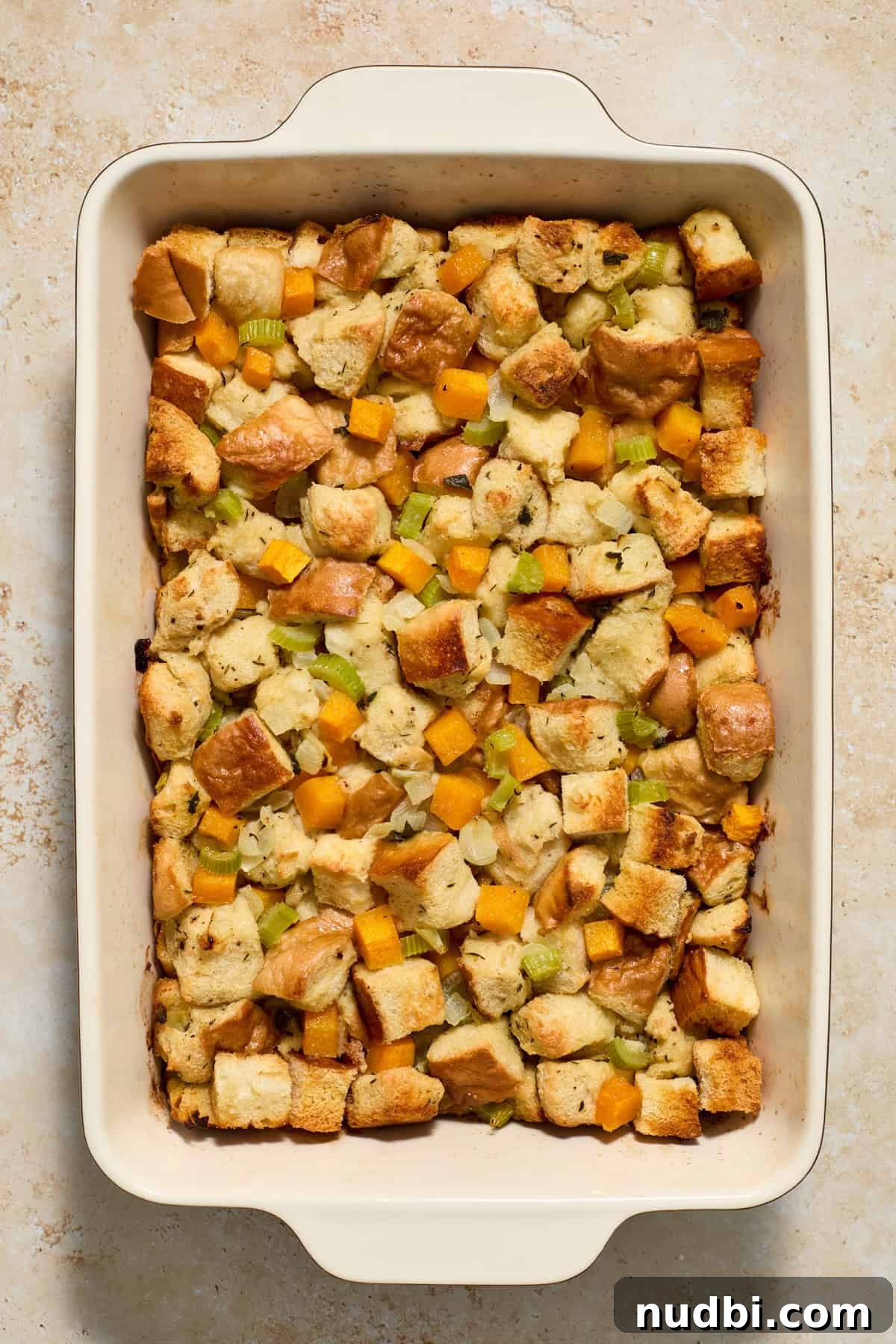 Savory Butternut Squash Stuffing Recipe for Holiday Dinners 9 Baked butternut squash stuffing just out of the oven in a pan.