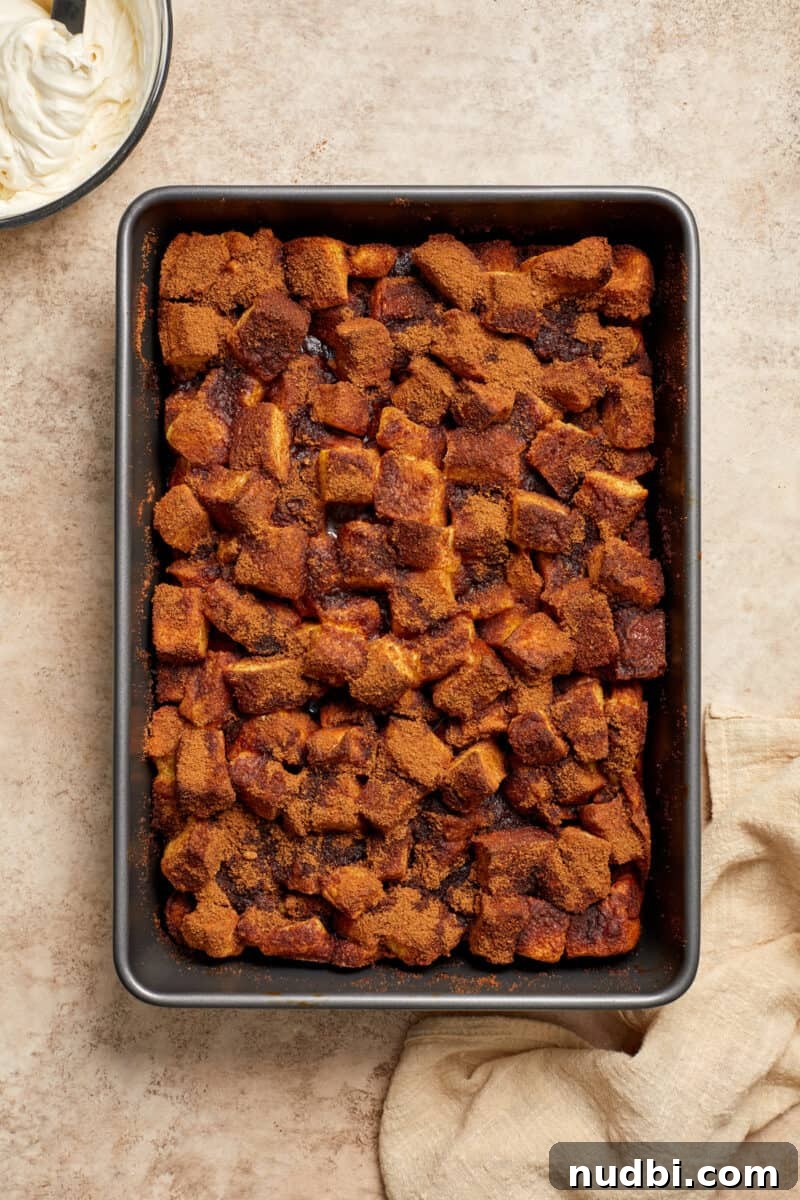 Cinnamon Roll Baked French Toast Recipe for Brunch 9 Baked cinnamon roll French toast casserole in pan.