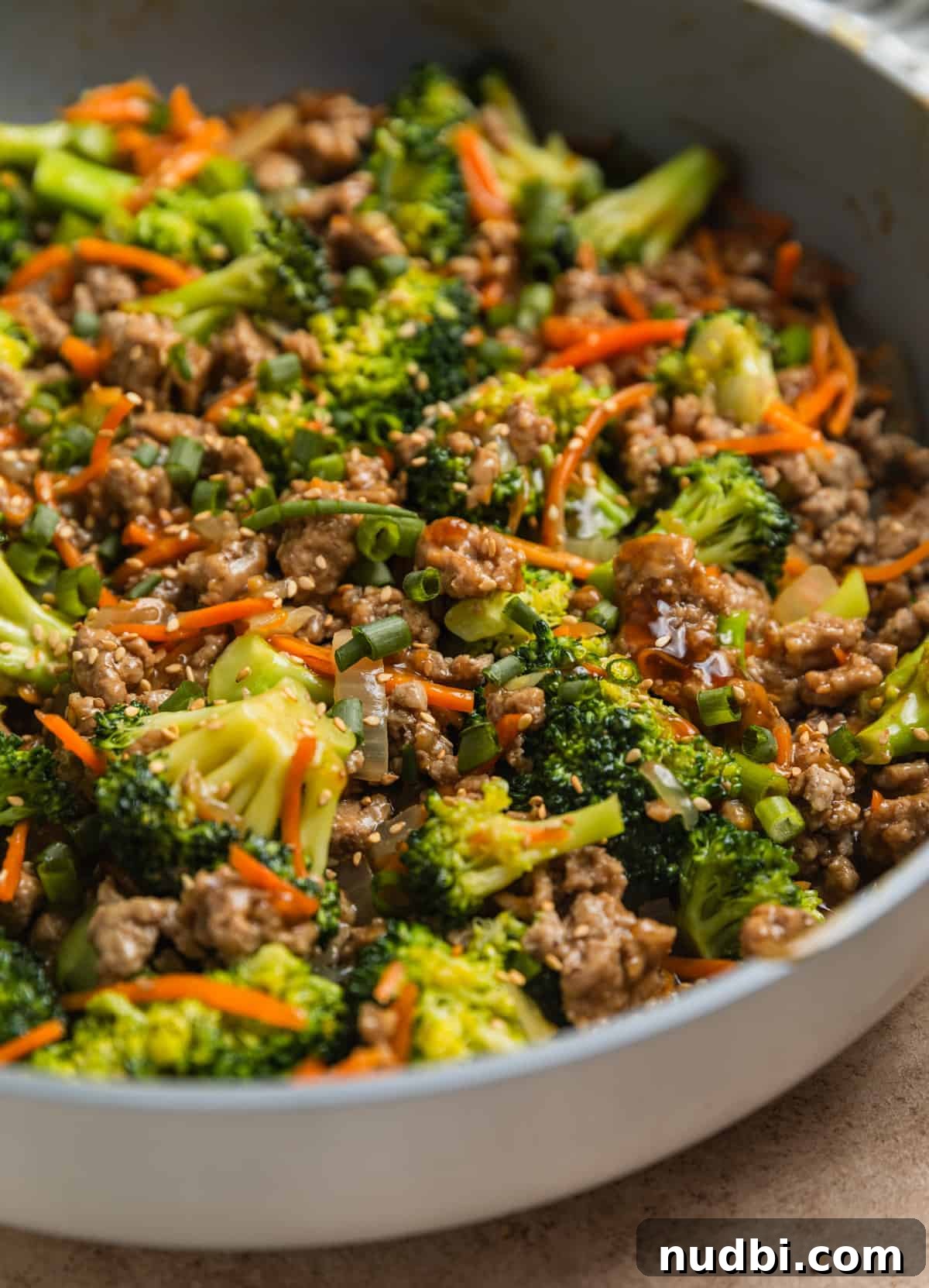 Teriyaki Ground Turkey Stir-Fry with Veggies and Rice 5 Stir fried ground turkey with carrots and broccoli in pan.