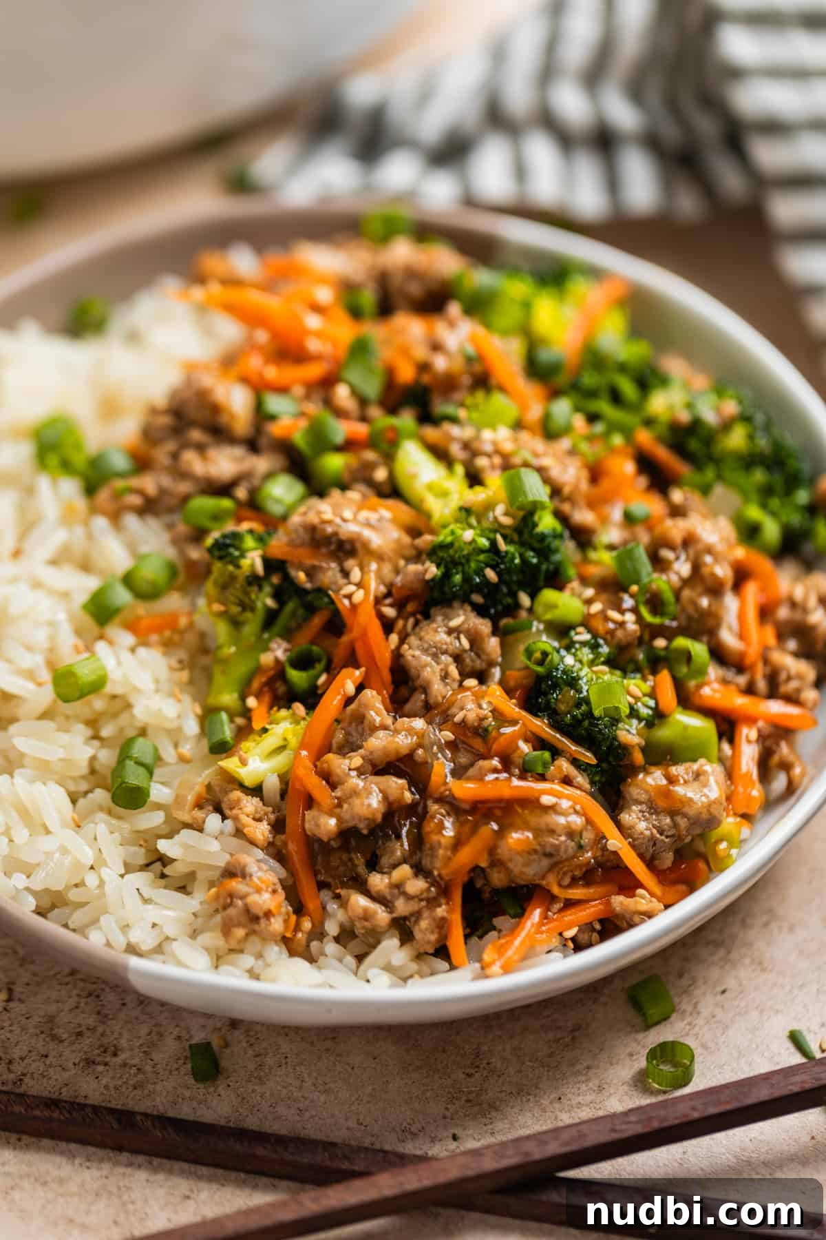 Teriyaki Ground Turkey Stir-Fry with Veggies and Rice 6 Rice and ground turkey stir fry with teriyaki sauce on plate.