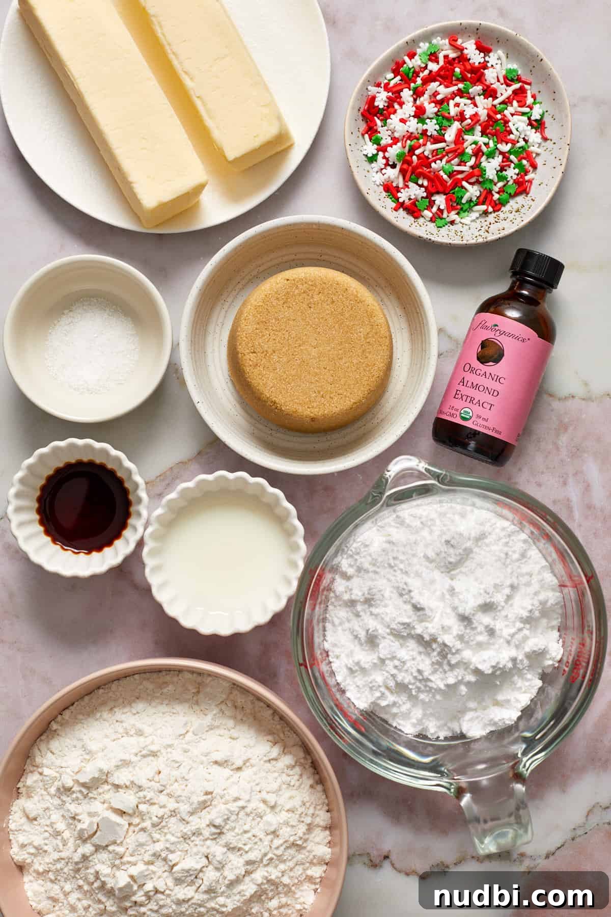 Classic Christmas Shortbread Cookies Recipe for the Holidays 4 Butter, brown sugar, almond extract, flour and other ingredients arranged on surface for recipe.