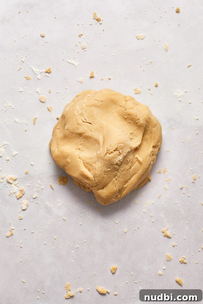 Classic Christmas Shortbread Cookies Recipe for the Holidays 7 Ball of cookie dough on floured surface.