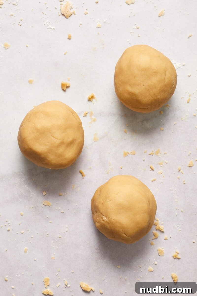 Classic Christmas Shortbread Cookies Recipe for the Holidays 8 3 smooth balls of brown sugar shortbread cookie dough on floured surface.