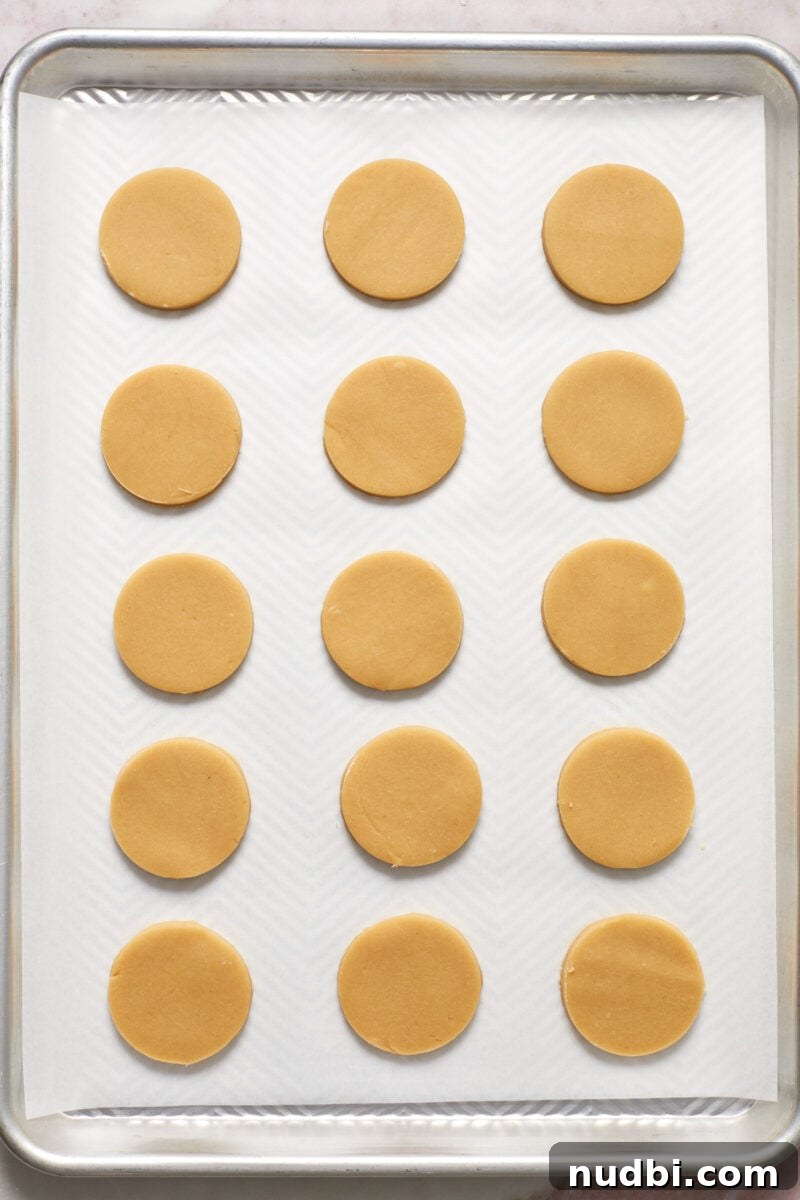 Classic Christmas Shortbread Cookies Recipe for the Holidays 10 Cookie cutouts lined on parchment lined baking sheet.