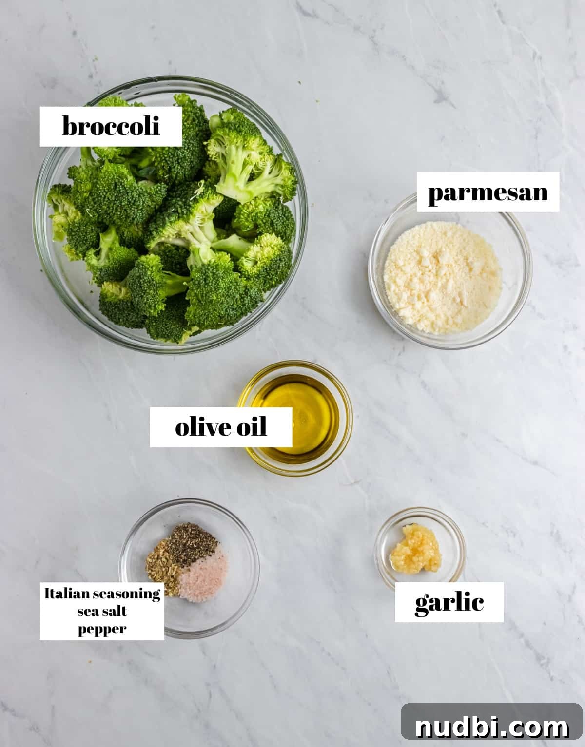 Crispy Air Fryer Broccoli with Garlic and Parmesan 3 Broccoli, garlic, olive oil and ingredients labeled on counter.