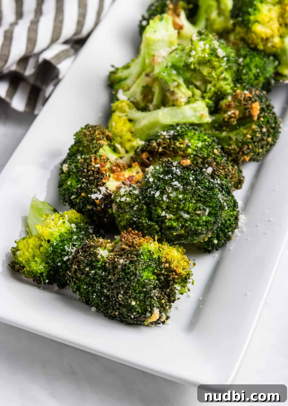 Crispy Air Fryer Broccoli with Garlic and Parmesan 6 Plate of air fried broccoli with parmesan.