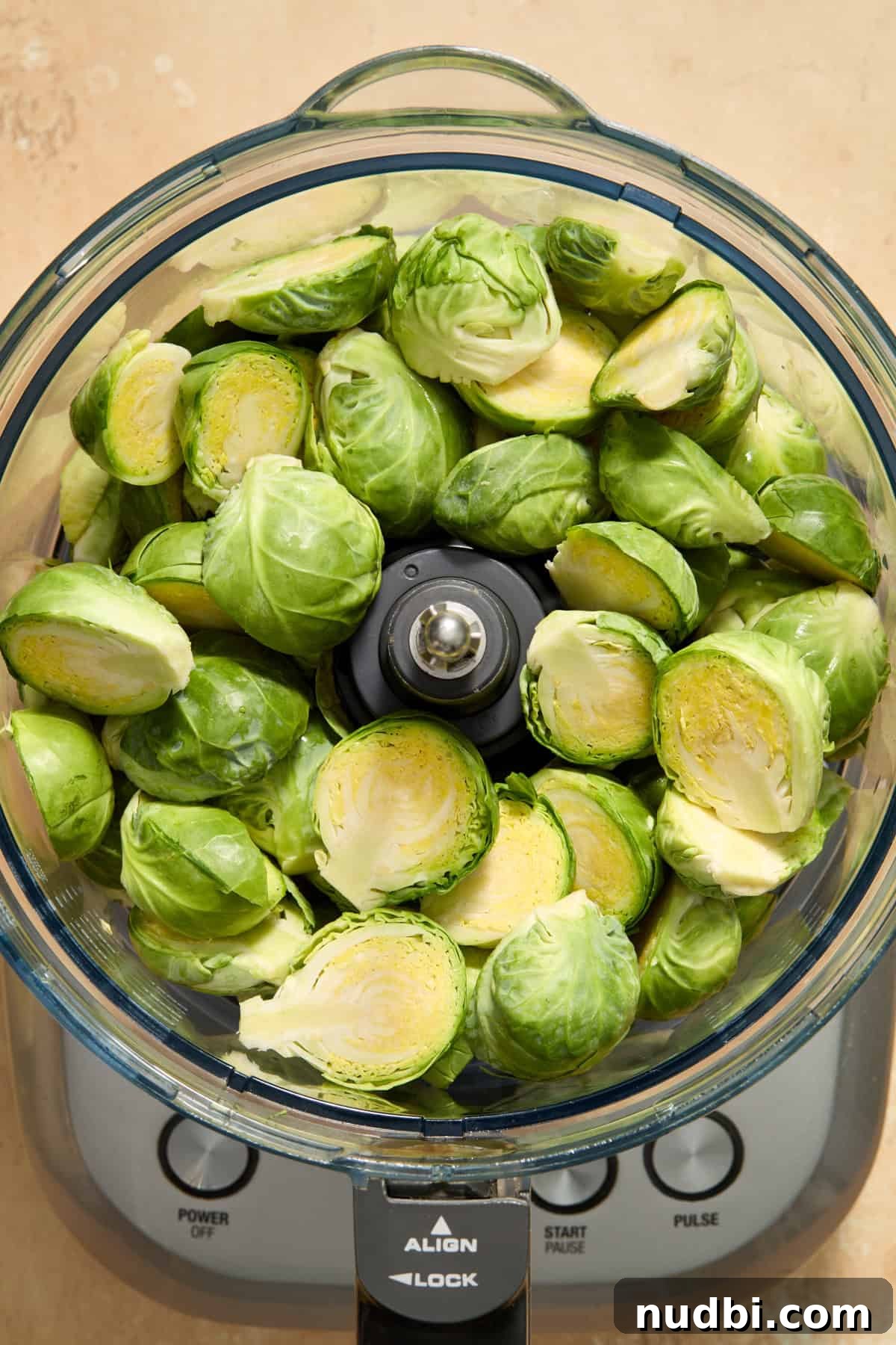 Crisp Shaved Brussels Sprout Salad with Lemon Parmesan Dressing 4 Brussels sprouts halved and added to food processor before being shredded.