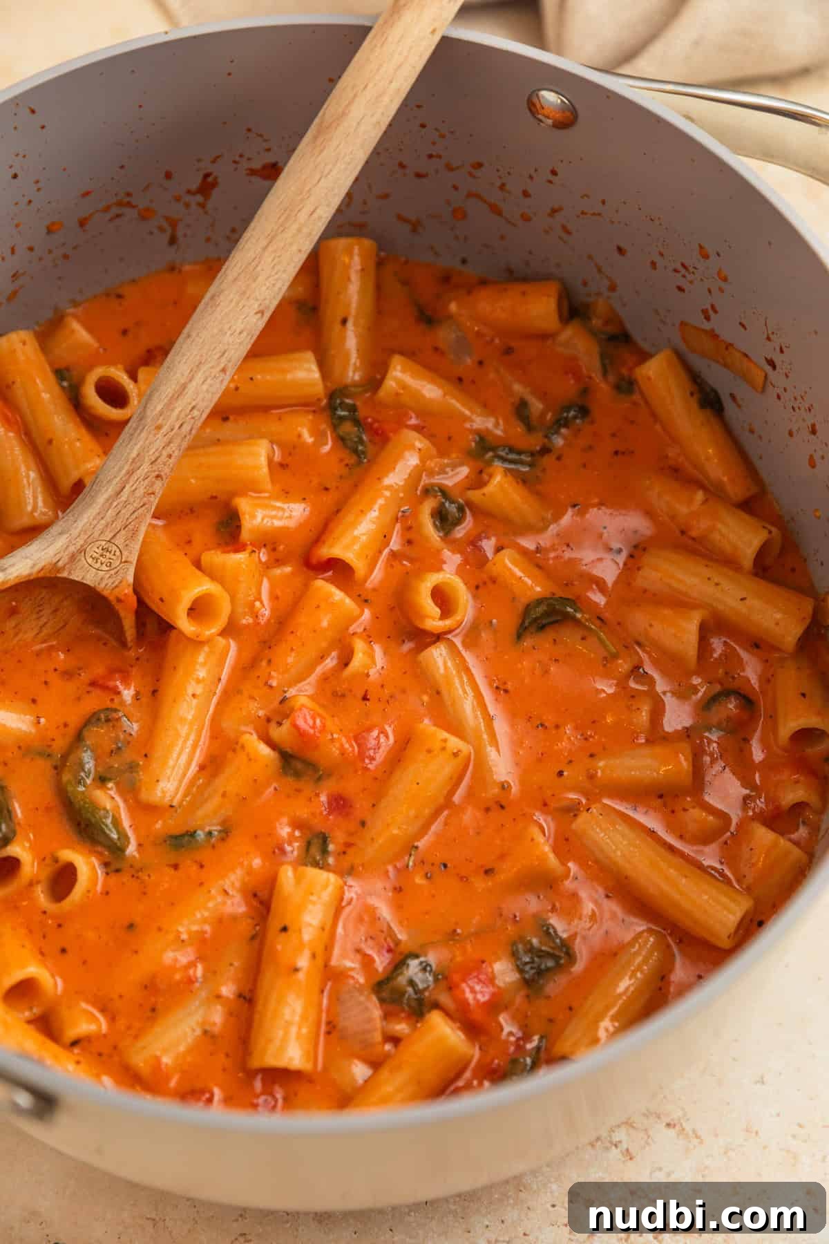 Creamy One-Pot Pasta Recipe for Quick Weeknight Meals 7 Creamy one pot pasta in pot with wooden spoon.