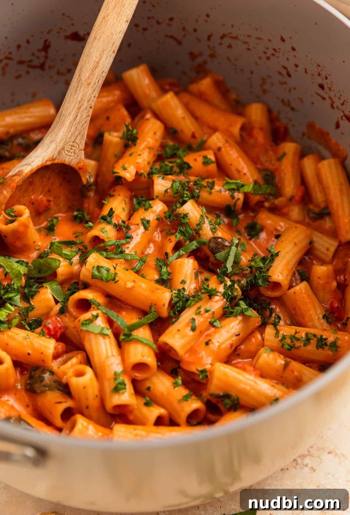 Creamy One-Pot Pasta Recipe for Quick Weeknight Meals 8 One pot creamy pasta in pot with wooden spoon.