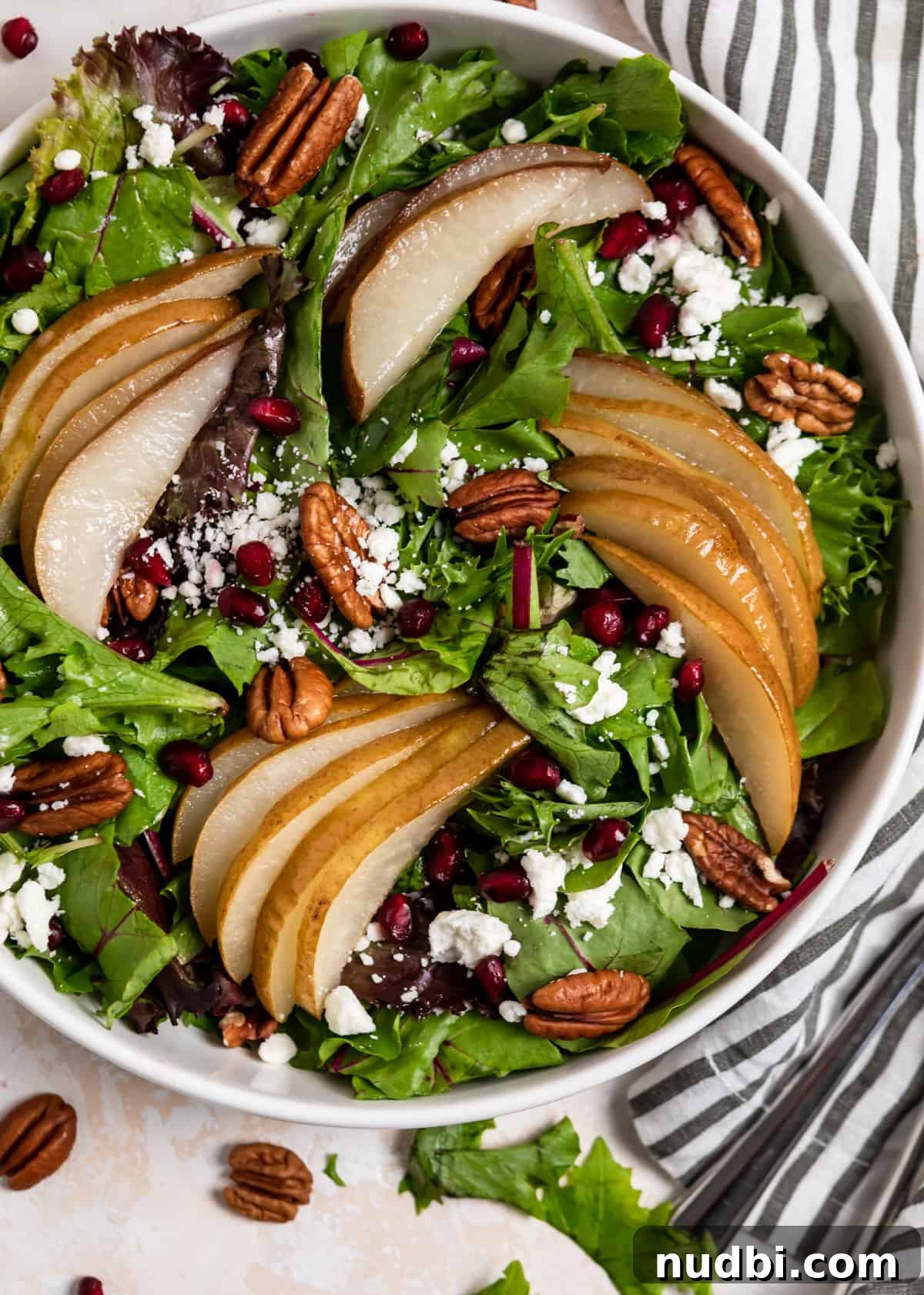 Warm Roasted Pear Salad with Goat Cheese and Candied Pecans 7 Overhead view of white bowl with pear salad.