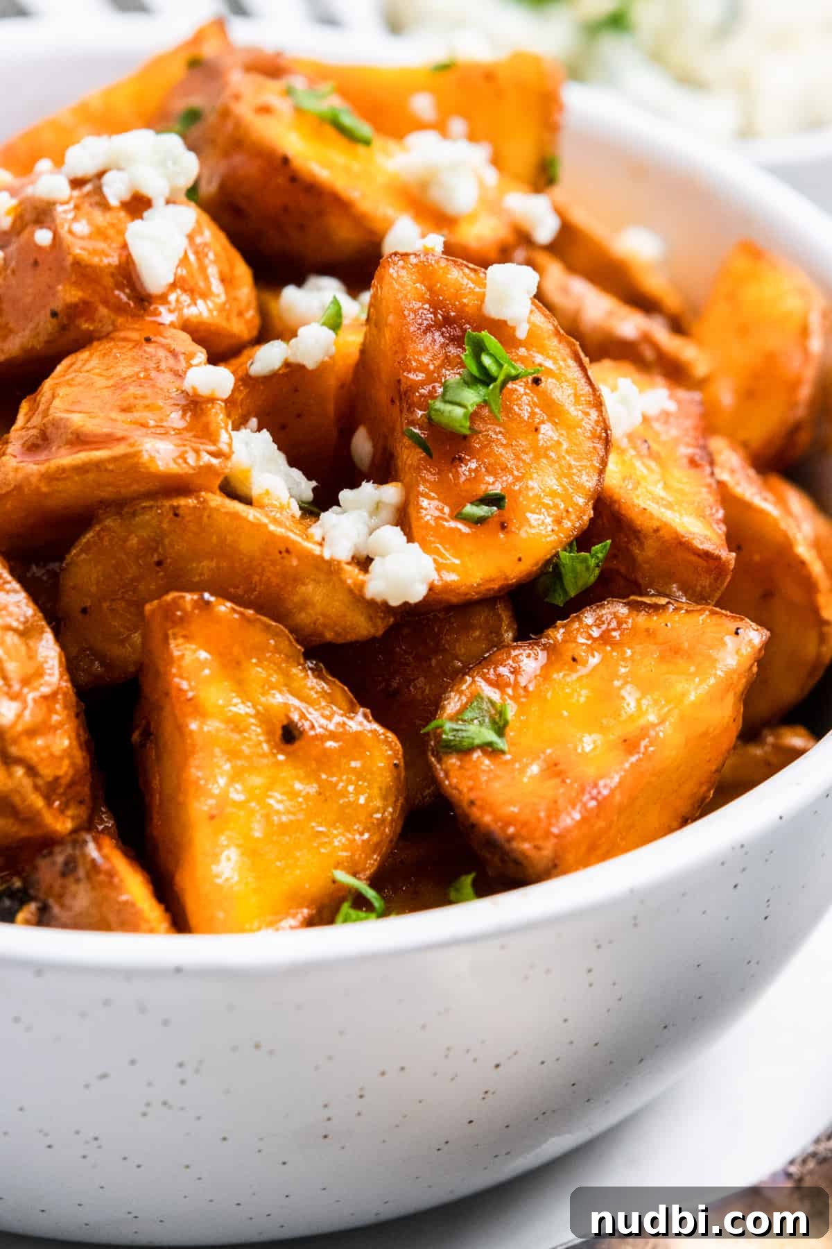 Crispy Buffalo-Style Air Fryer Baby Potatoes 2 Air fryer mini buffalo potatoes in bowl with parsley and blue cheese.