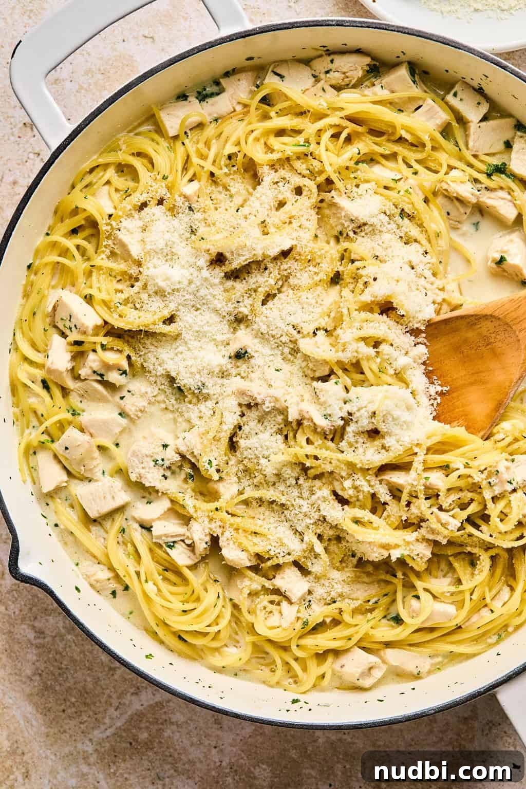 Creamy Chicken Alfredo Dinner Recipe in 30 Minutes 6 Parmesan added to pot with chicken alfredo.