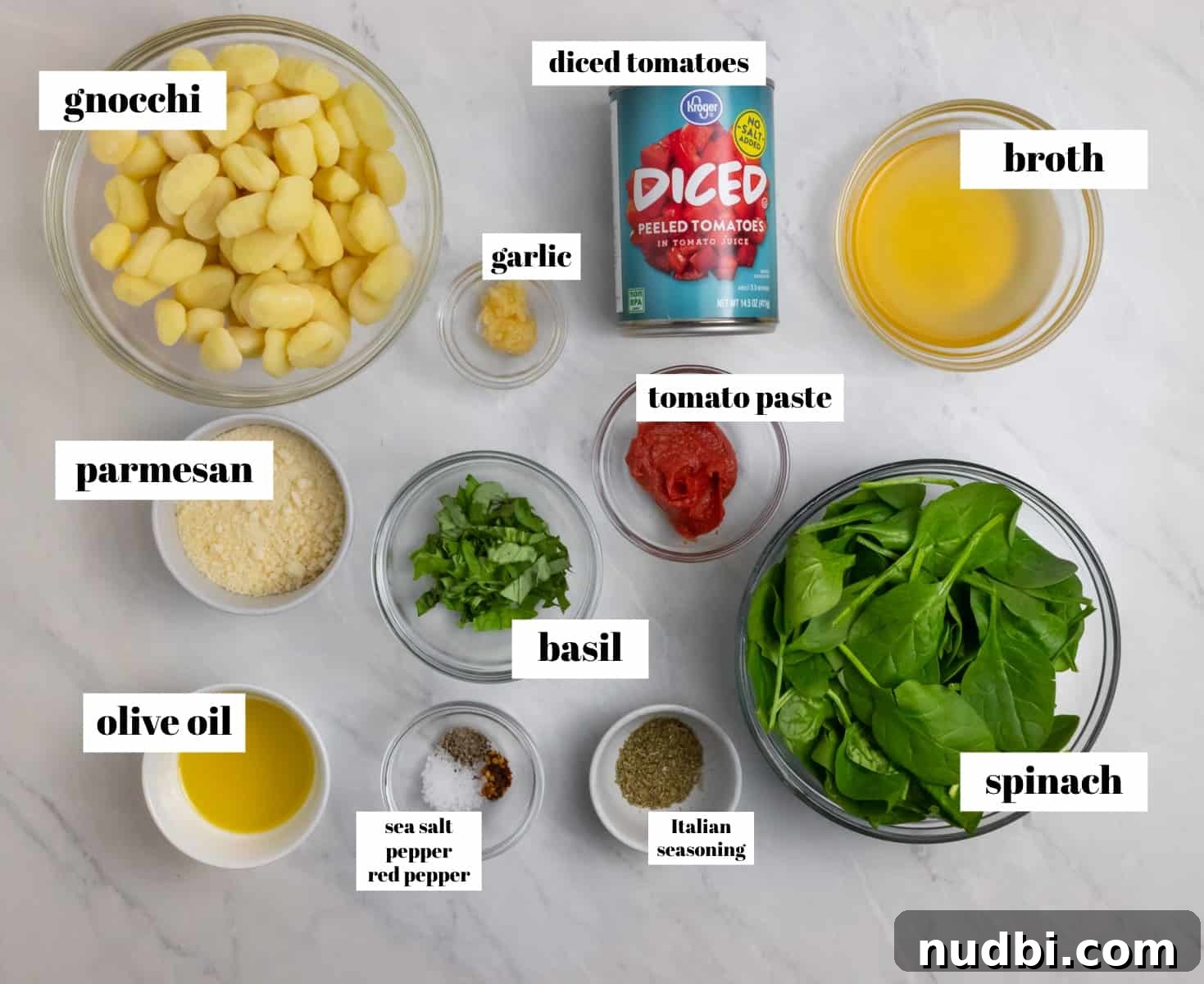 15-Minute Tomato Basil Gnocchi Recipe for Quick Weeknight Meals 3 Spinach, broth, parmesan and ingredients labeled on counter.