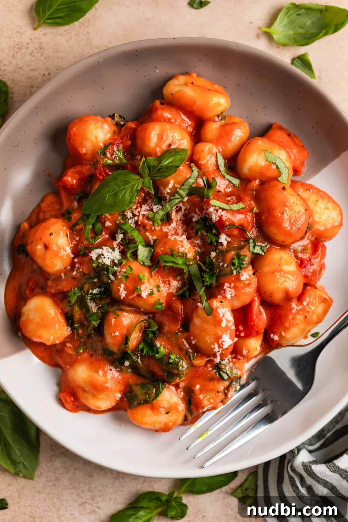 15-Minute Tomato Basil Gnocchi Recipe for Quick Weeknight Meals 9 Plate with 15 minute tomato gnocchi topped with chopped basil, parsley and parmesan.