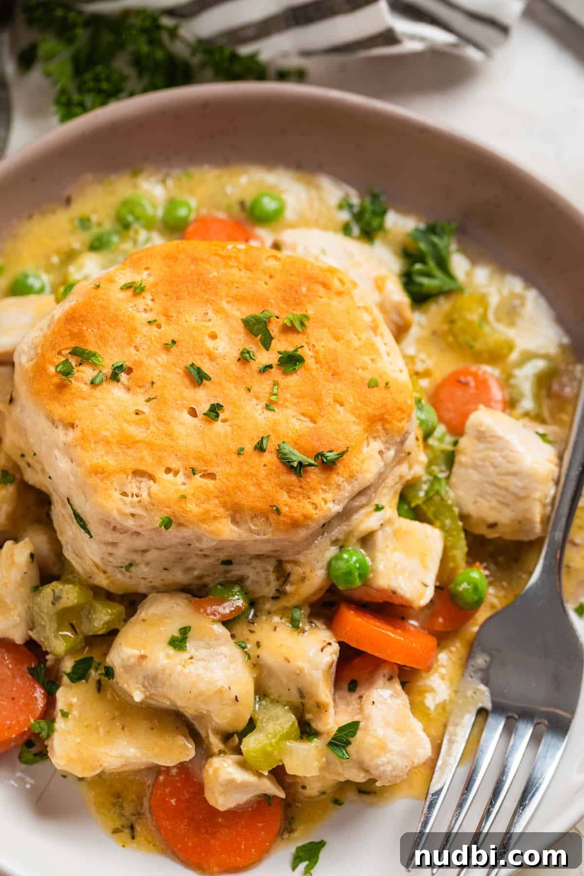 One-Pan Chicken and Biscuits Skillet Recipe 2 Chicken and biscuit dinner on plate with fork.