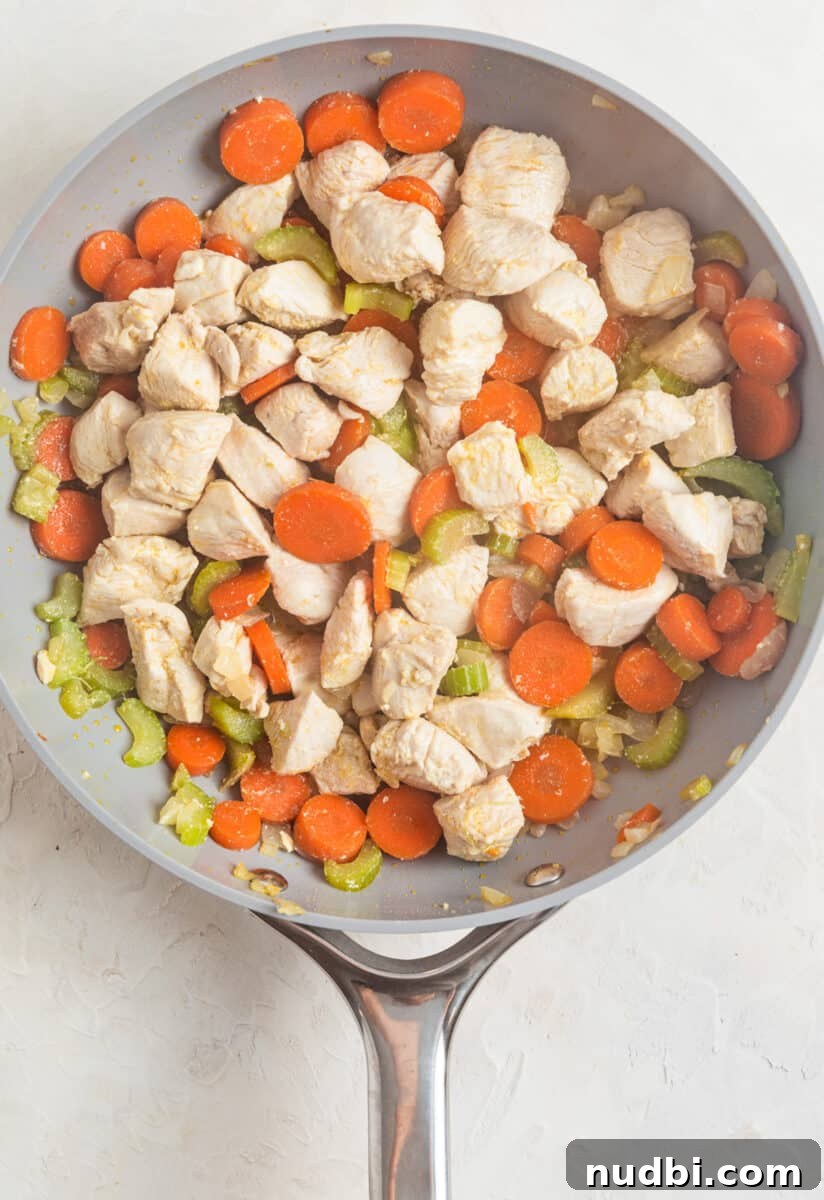 One-Pan Chicken and Biscuits Skillet Recipe 5 Diced chicken cooked in skillet with carrots, celery and onion.