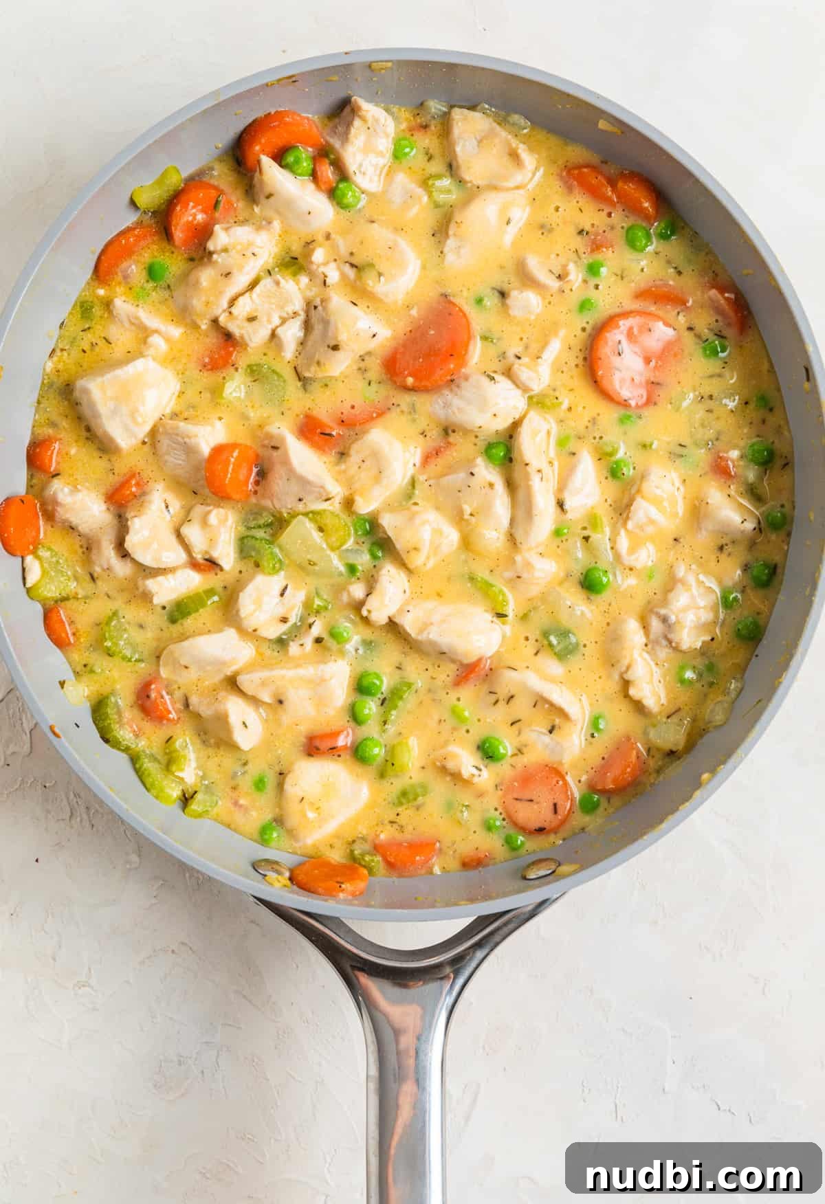 One-Pan Chicken and Biscuits Skillet Recipe 7 Chicken and biscuit chicken mixture in skillet before baking.