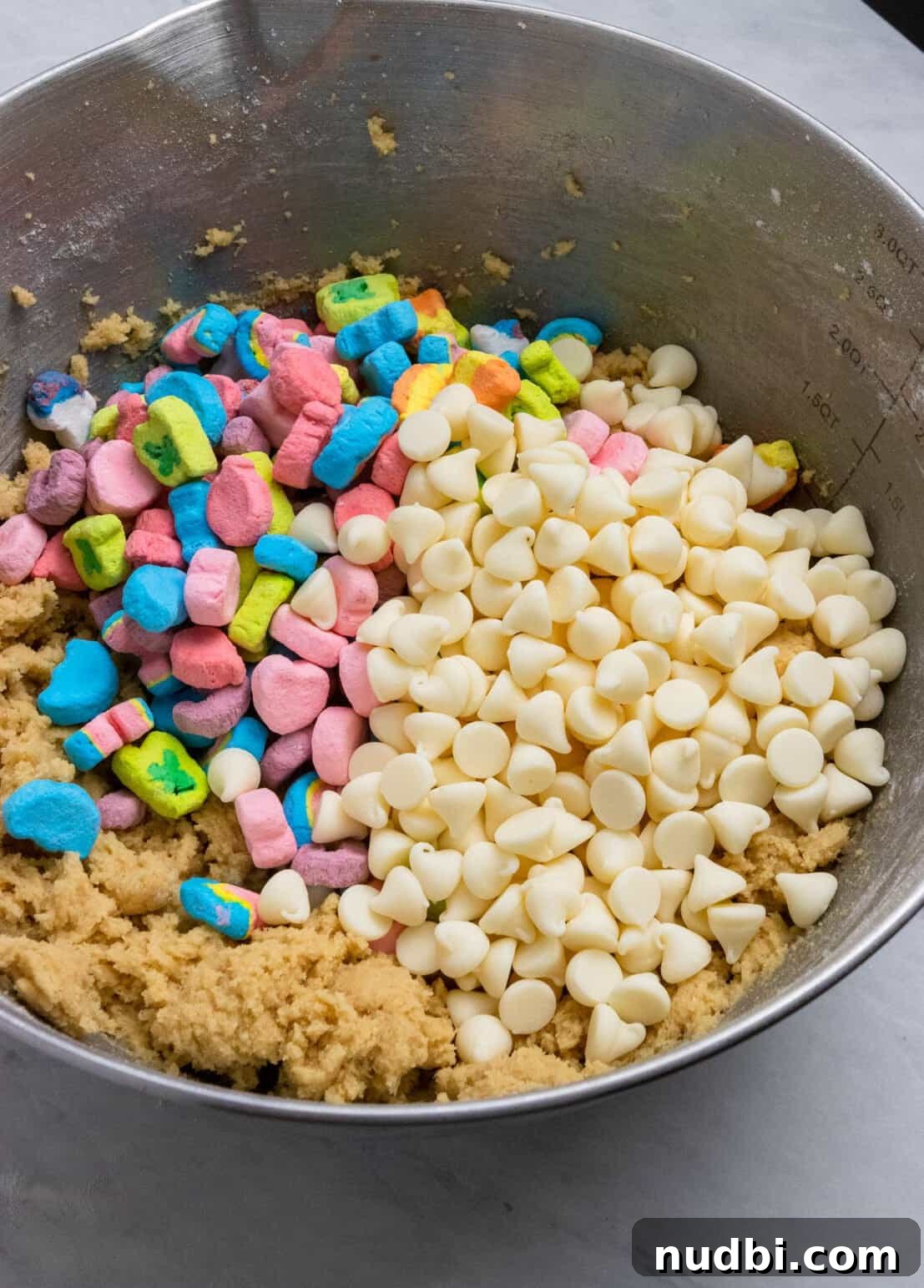 How to Make Lucky Charms Cookies (St. Patrick’s Treat) 7 White chocolate chips and mini marshmallows added to cookie dough mixing bowl.