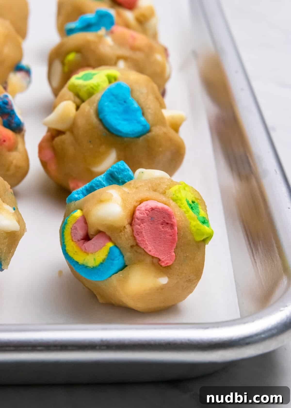 How to Make Lucky Charms Cookies (St. Patrick’s Treat) 9 Lucky Charm cookie dough scooped onto parchment lined