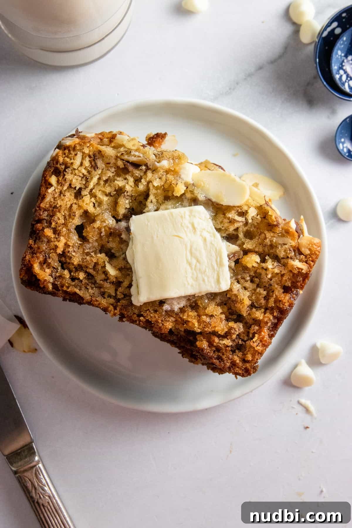 10 Delicious Ways to Use Overripe Bananas 2 Banana bread made with ripe bananas on plate with butter.