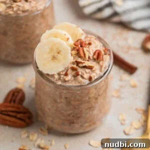 Glass jar with overnight oatmeal topped with bananas and nuts.