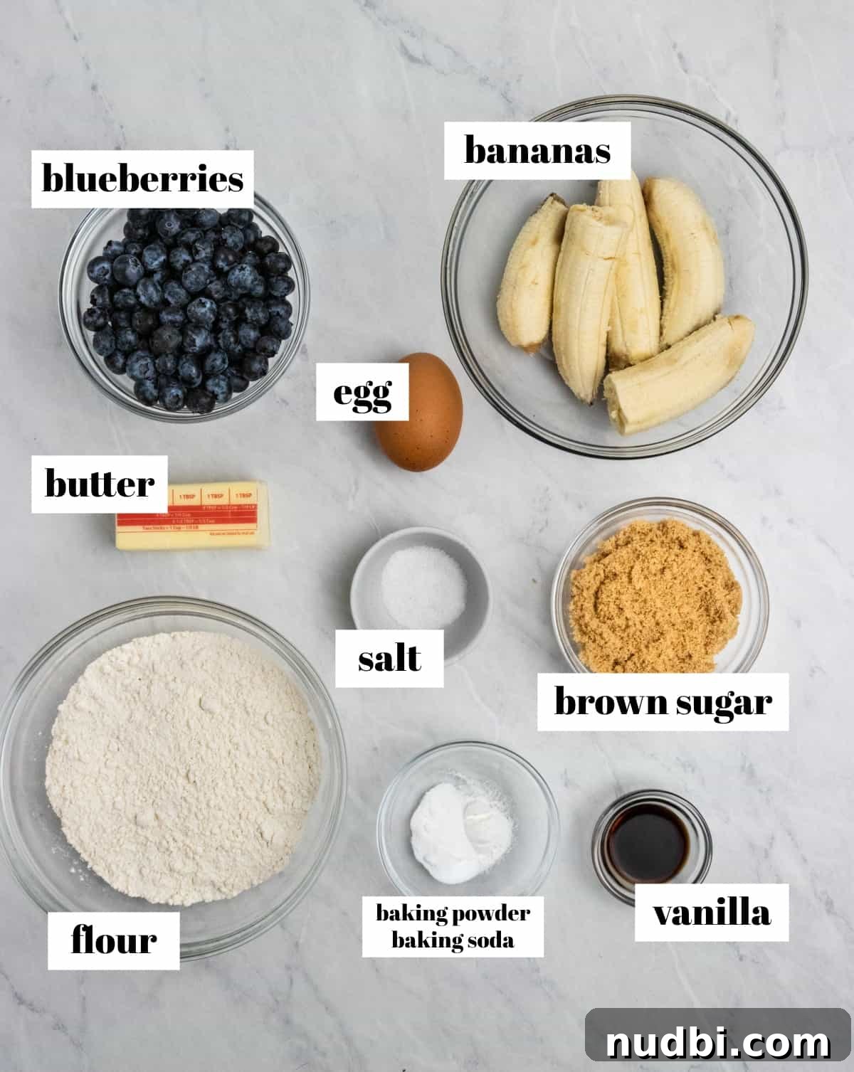 Moist Banana Blueberry Muffins with a Crunchy Streusel 3 Flour, butter, brown sugar and other ingredients on counter labeled.