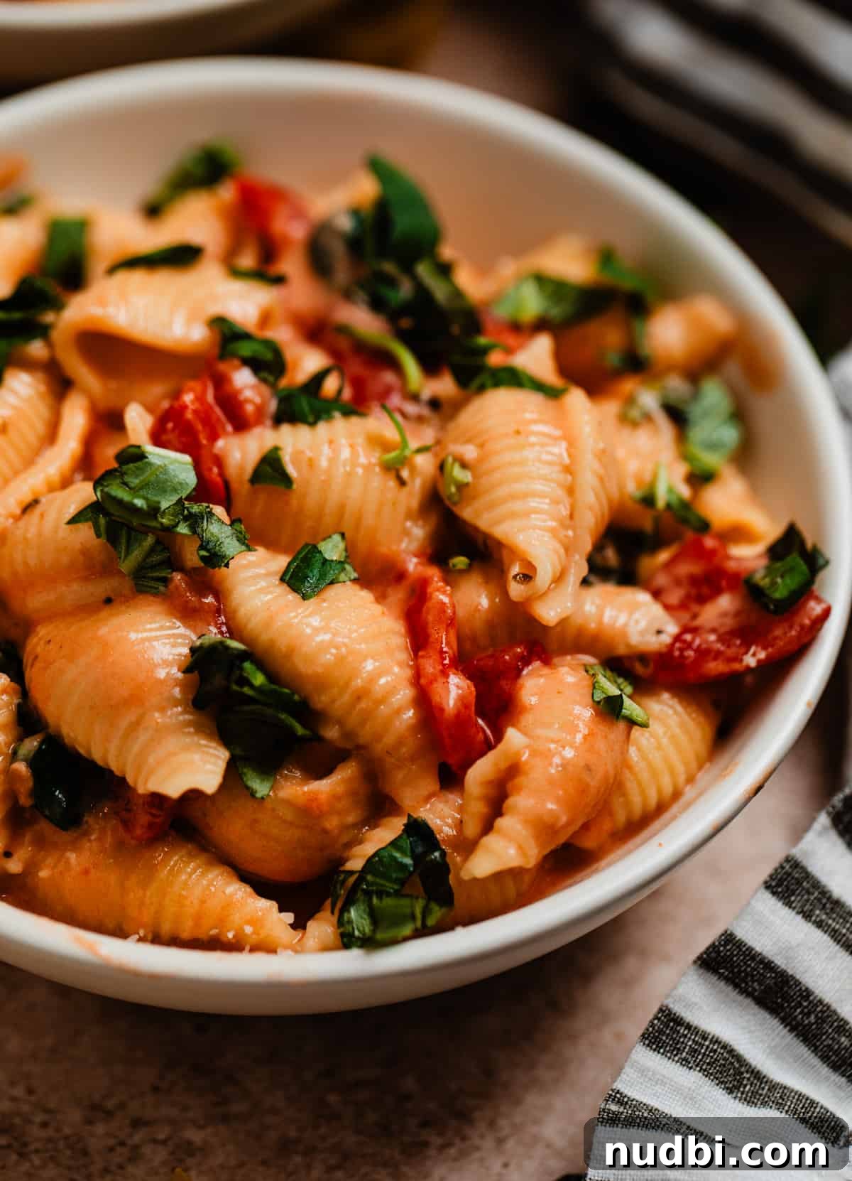 Creamy Parmesan Pasta Made in the Instant Pot in 20 Minutes 2 Bowl of creamy Instant pot pasta topped with chopped basil.