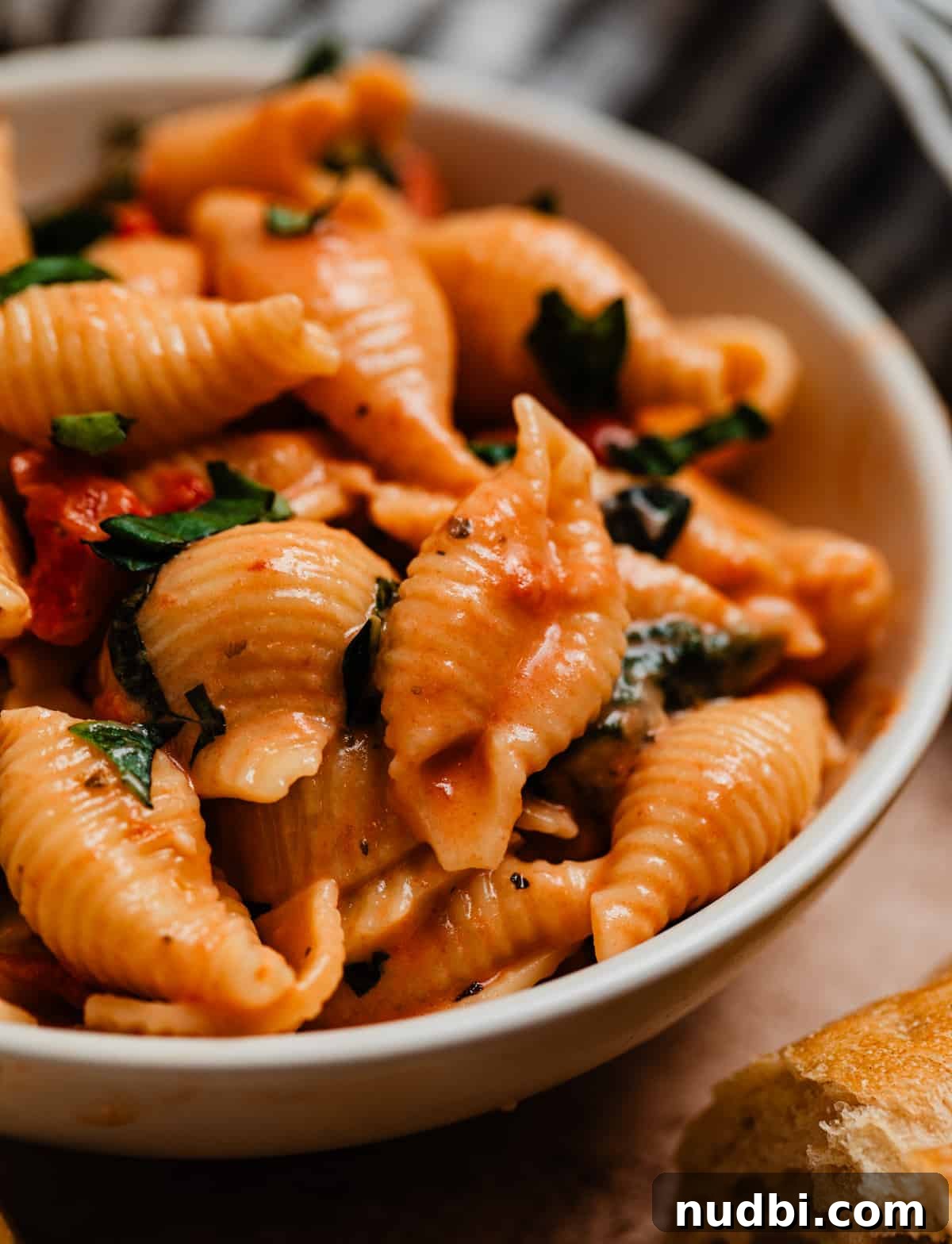 Creamy Parmesan Pasta Made in the Instant Pot in 20 Minutes 5 White dish with creamy pasta topped with basil.