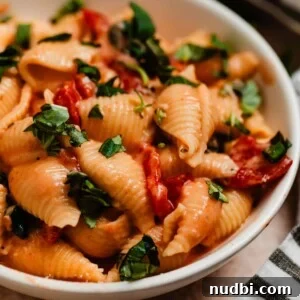 Creamy Parmesan Pasta Made in the Instant Pot in 20 Minutes 6 Creamy pasta with tomatoes and spinach topped with chopped fresh basil.