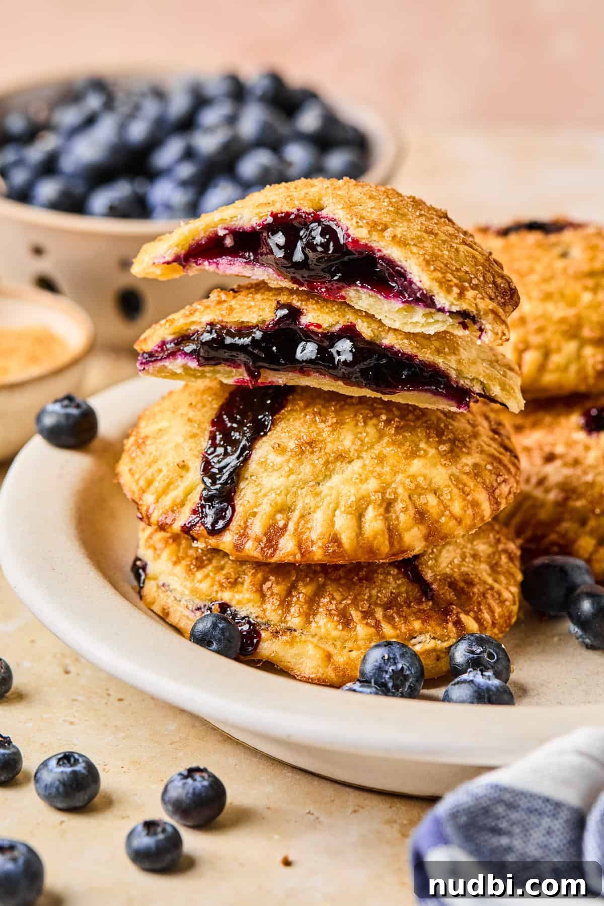Air Fryer Blueberry Hand Pies Recipe 2 Plate with stacked air fryer hand pies with blueberry filling.