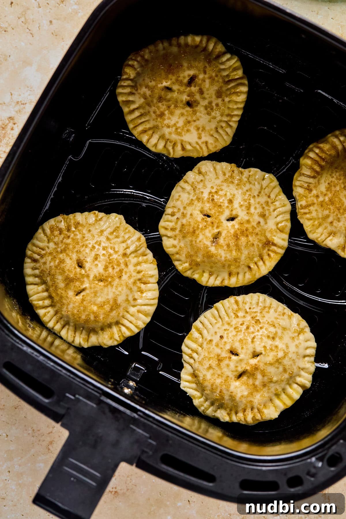 Air Fryer Blueberry Hand Pies Recipe 15 Air Fryer blue berry hand pies in air fryer basket before cooking.