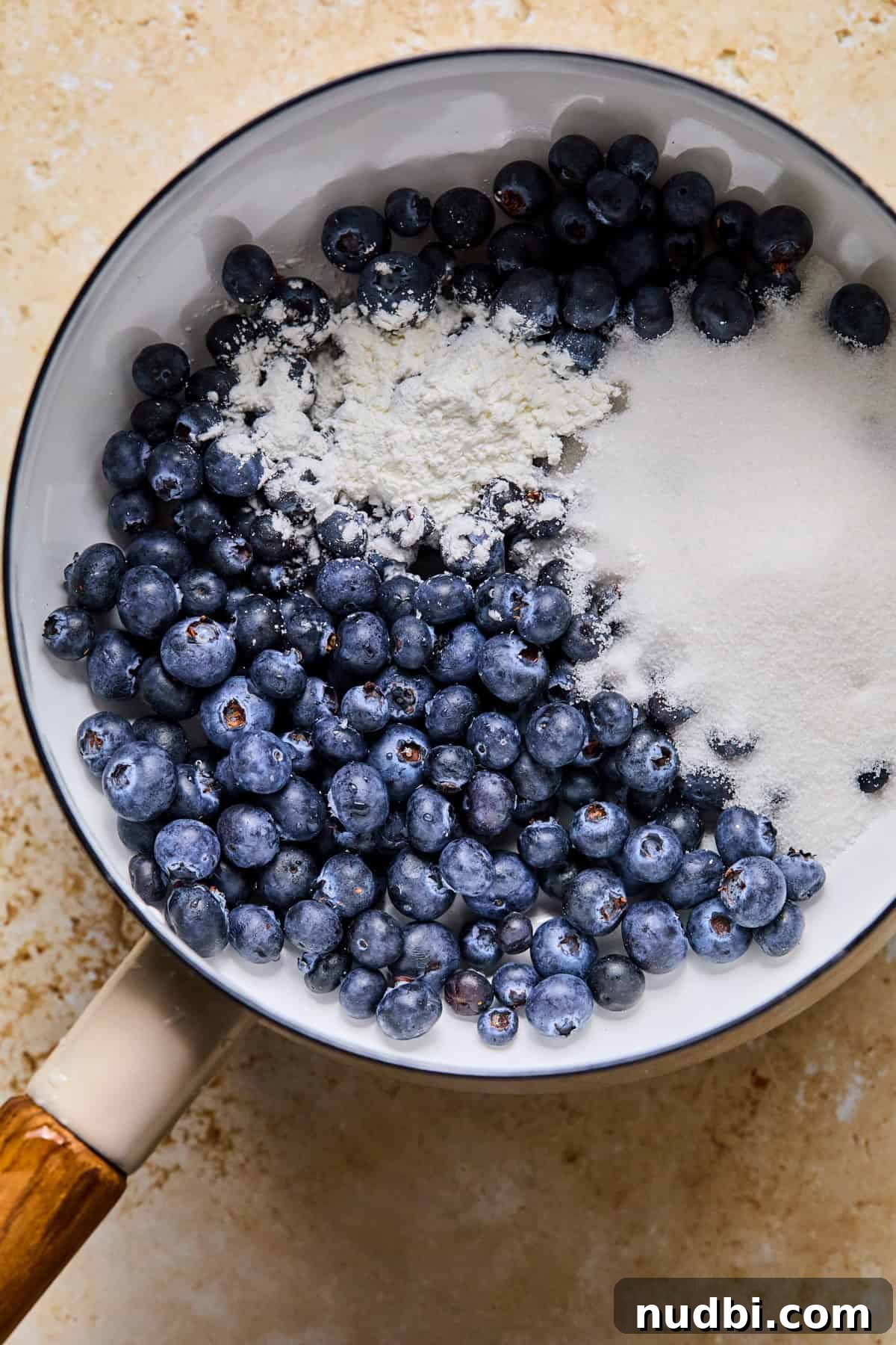 Air Fryer Blueberry Hand Pies Recipe 9 Fresh blueberries, sugar and cornstarch in pot.
