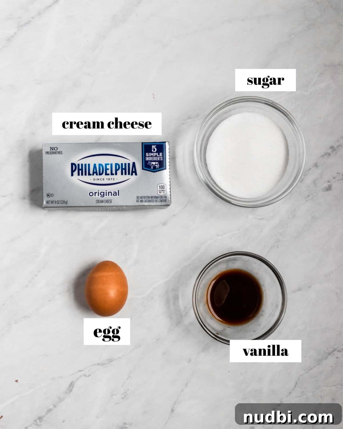 Mini Egg Cheesecake Cookie Bars Recipe for Spring Desserts 4 Cream cheese, egg, vanilla and sugar labeled on counter.
