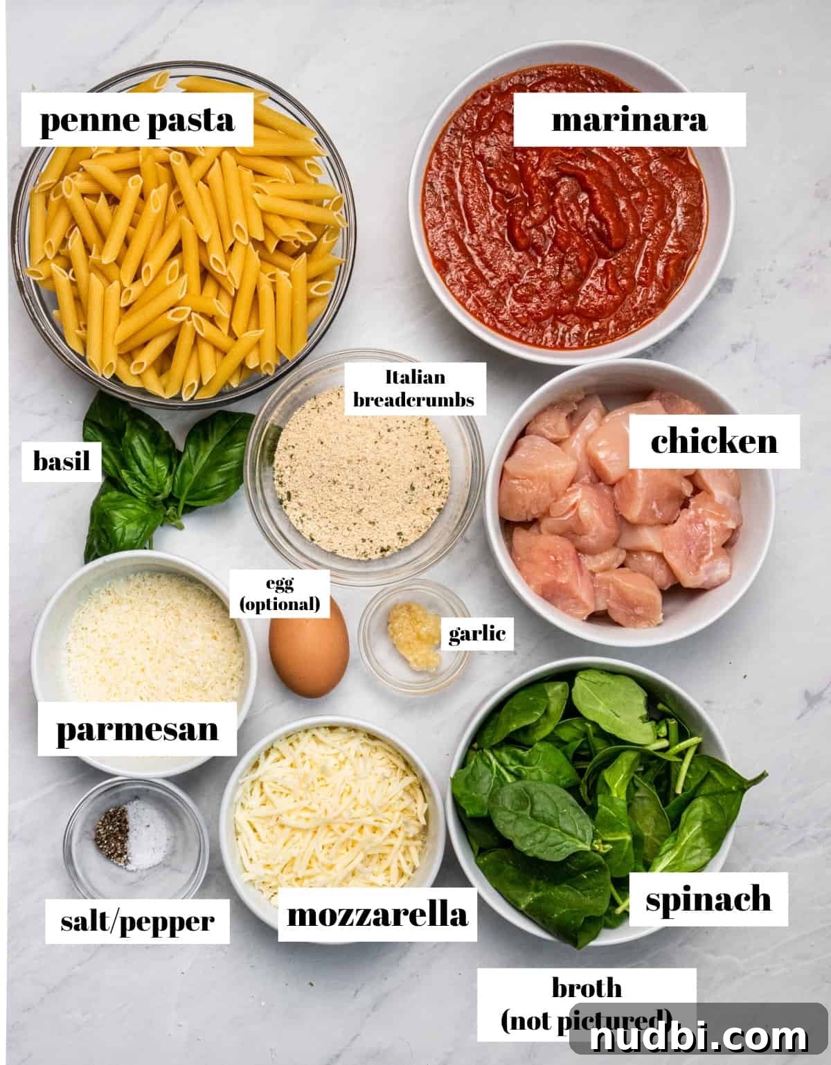 Cheesy Chicken Parmesan Casserole Bake for Weeknight Dinners 3 Pasta, marinara, cheese and other ingredients labeled on counter.