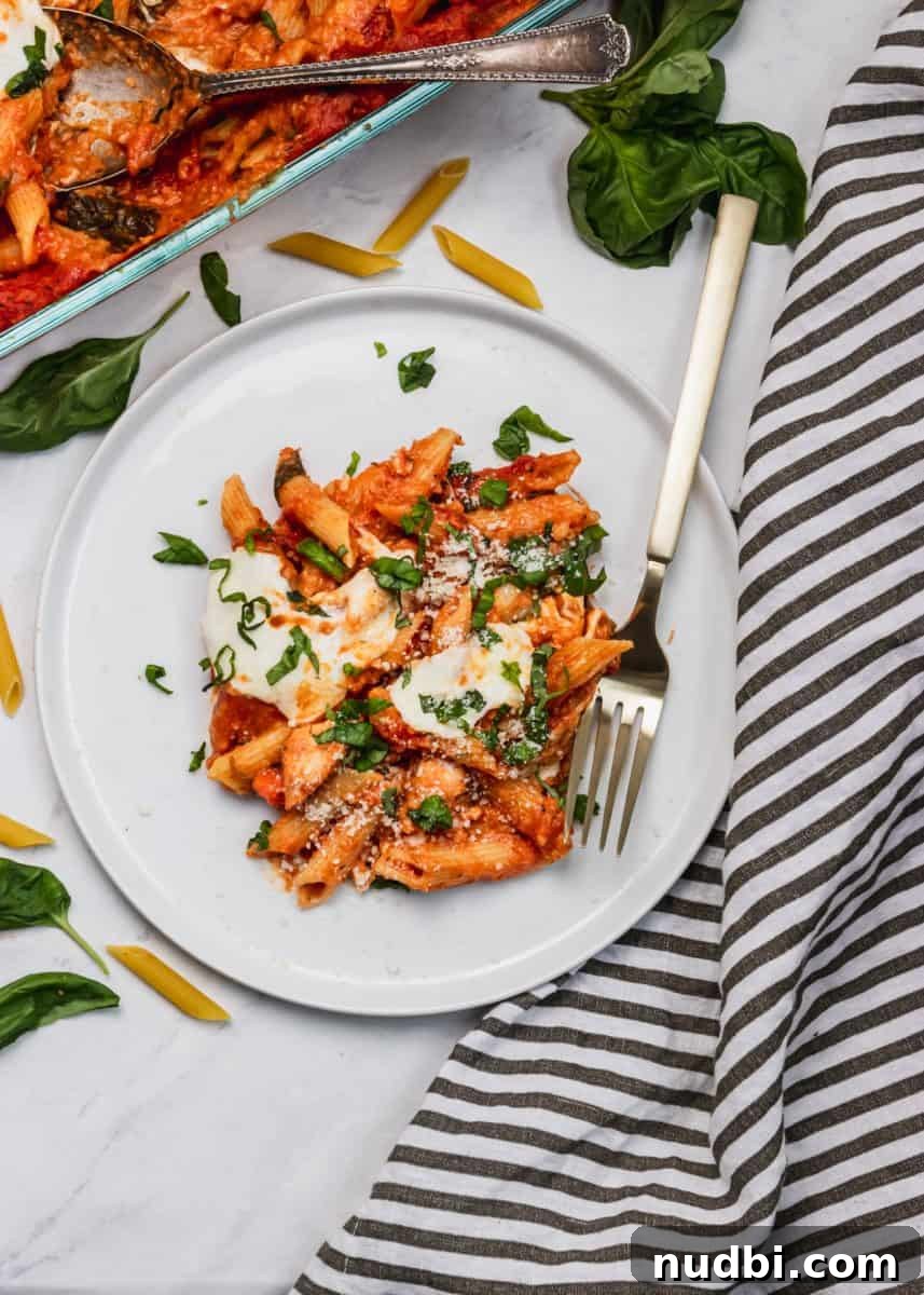 Cheesy Chicken Parmesan Casserole Bake for Weeknight Dinners 6 Overhead view of pasta on plate with fork.