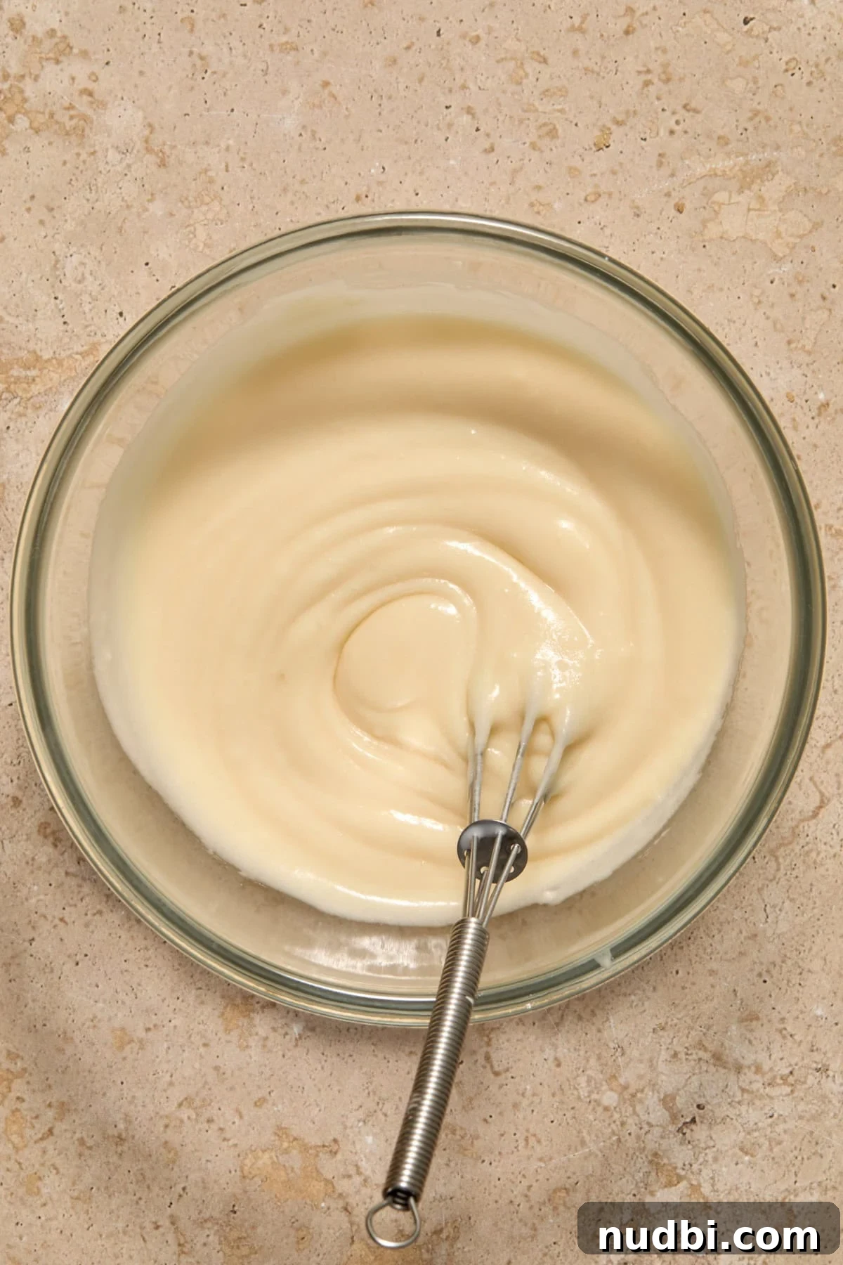 Quick Puff Pastry Cinnamon Rolls with Sticky Cinnamon Glaze 11 Whisked maple icing in bowl.