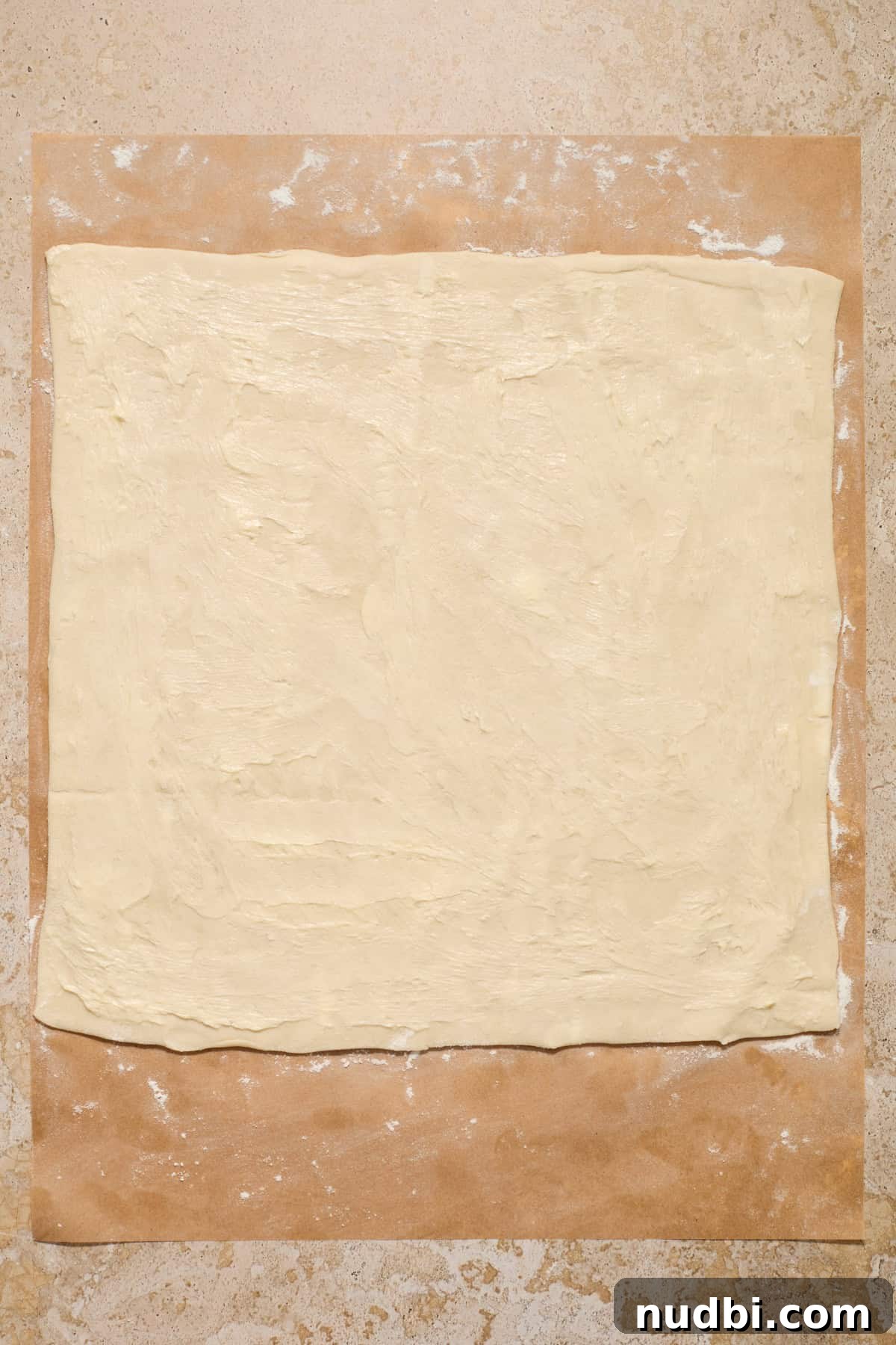 Quick Puff Pastry Cinnamon Rolls with Sticky Cinnamon Glaze 5 Butter spread over puff pastry sheet.
