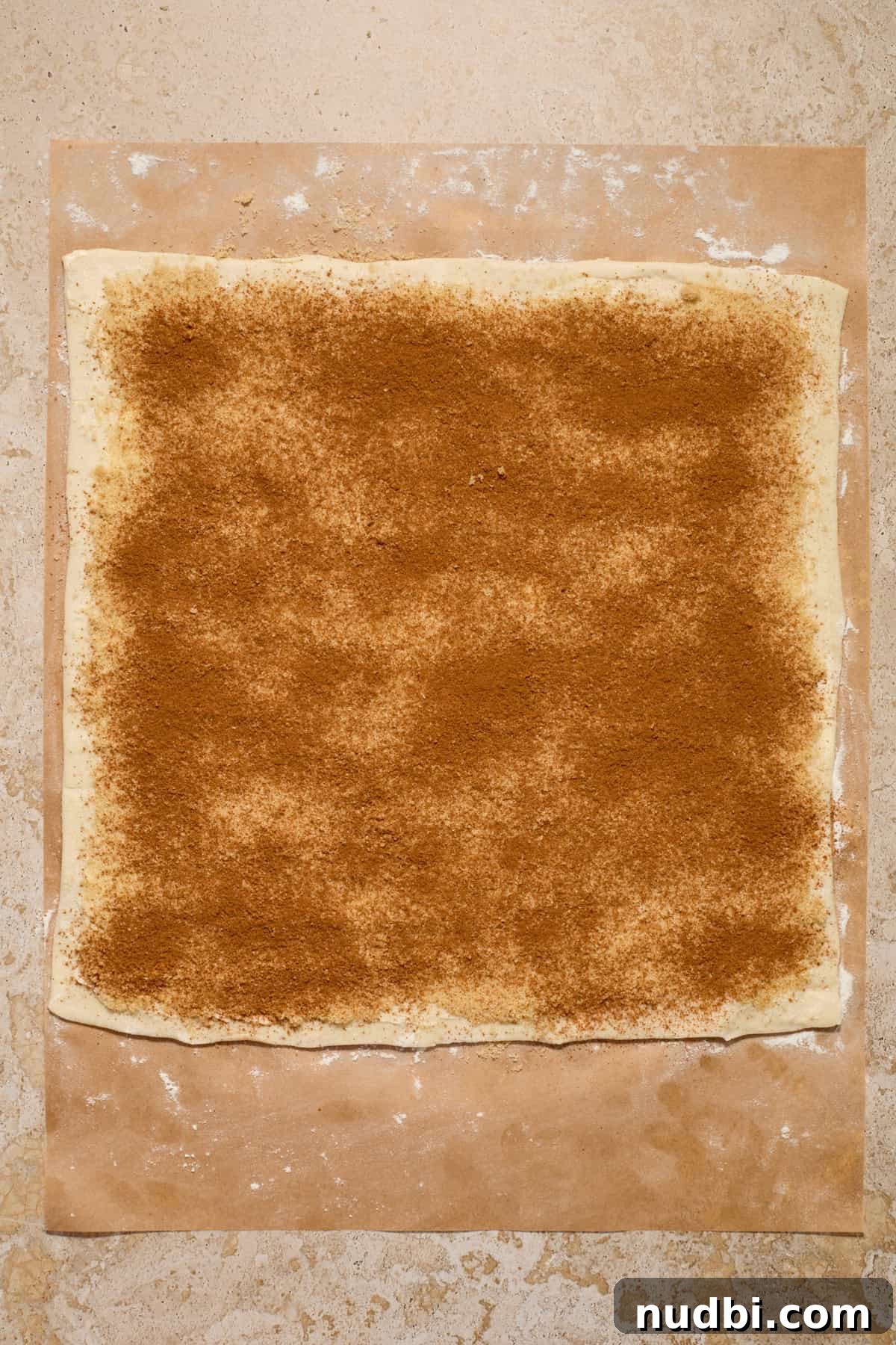 Quick Puff Pastry Cinnamon Rolls with Sticky Cinnamon Glaze 6 Brown sugar and cinnamon spread on puff pastry dough.