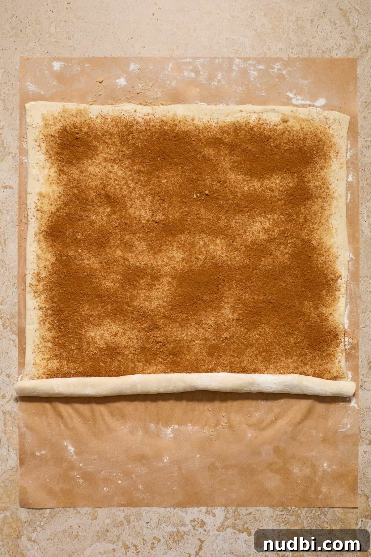 Quick Puff Pastry Cinnamon Rolls with Sticky Cinnamon Glaze 7 Cinnamon roll with the start of rolling up.