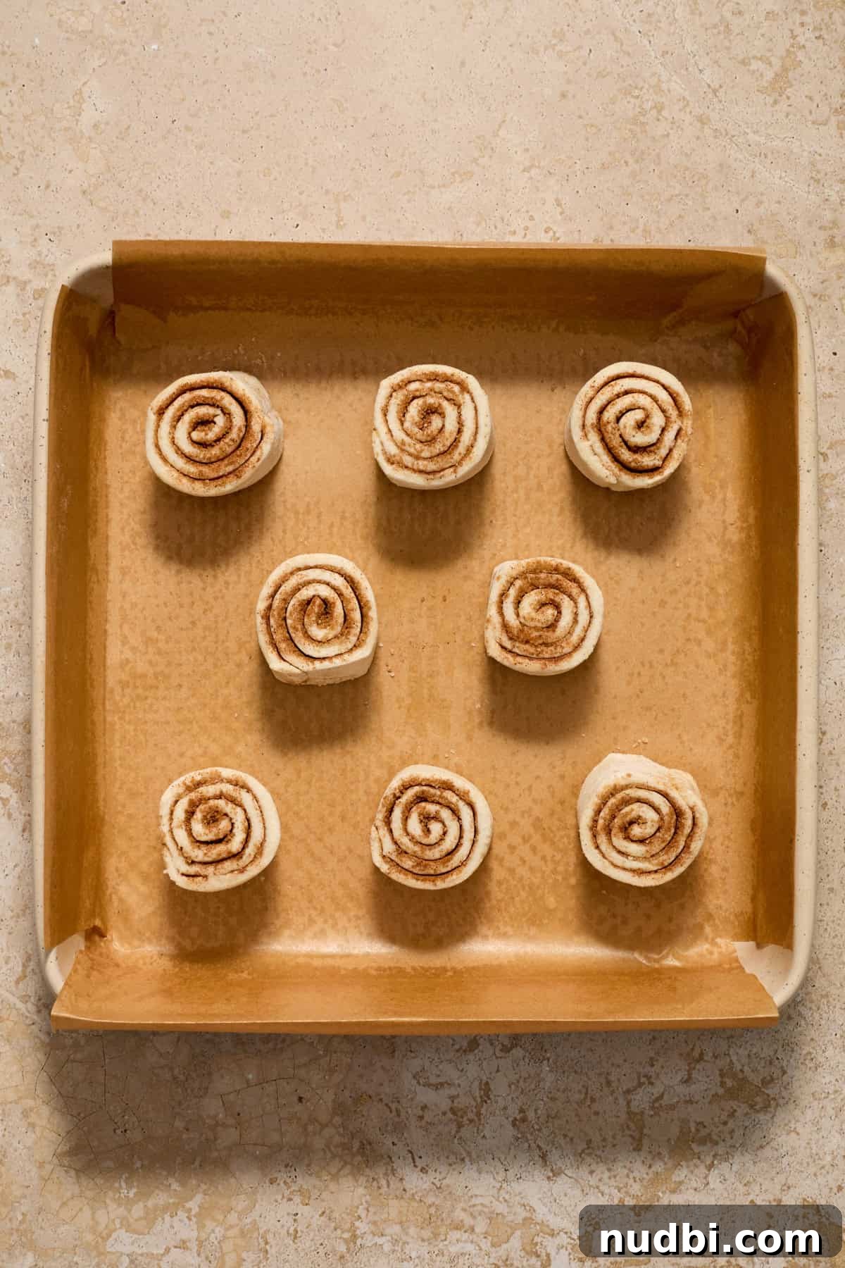 Quick Puff Pastry Cinnamon Rolls with Sticky Cinnamon Glaze 9 Baking pan with prepped cinnamon rolls before baking.