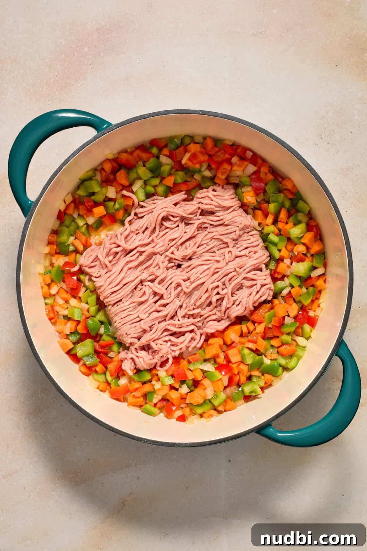 Savory Ground Turkey Spaghetti Sauce Recipe 6 Ground turkey added to pot with sautéed vegetables.