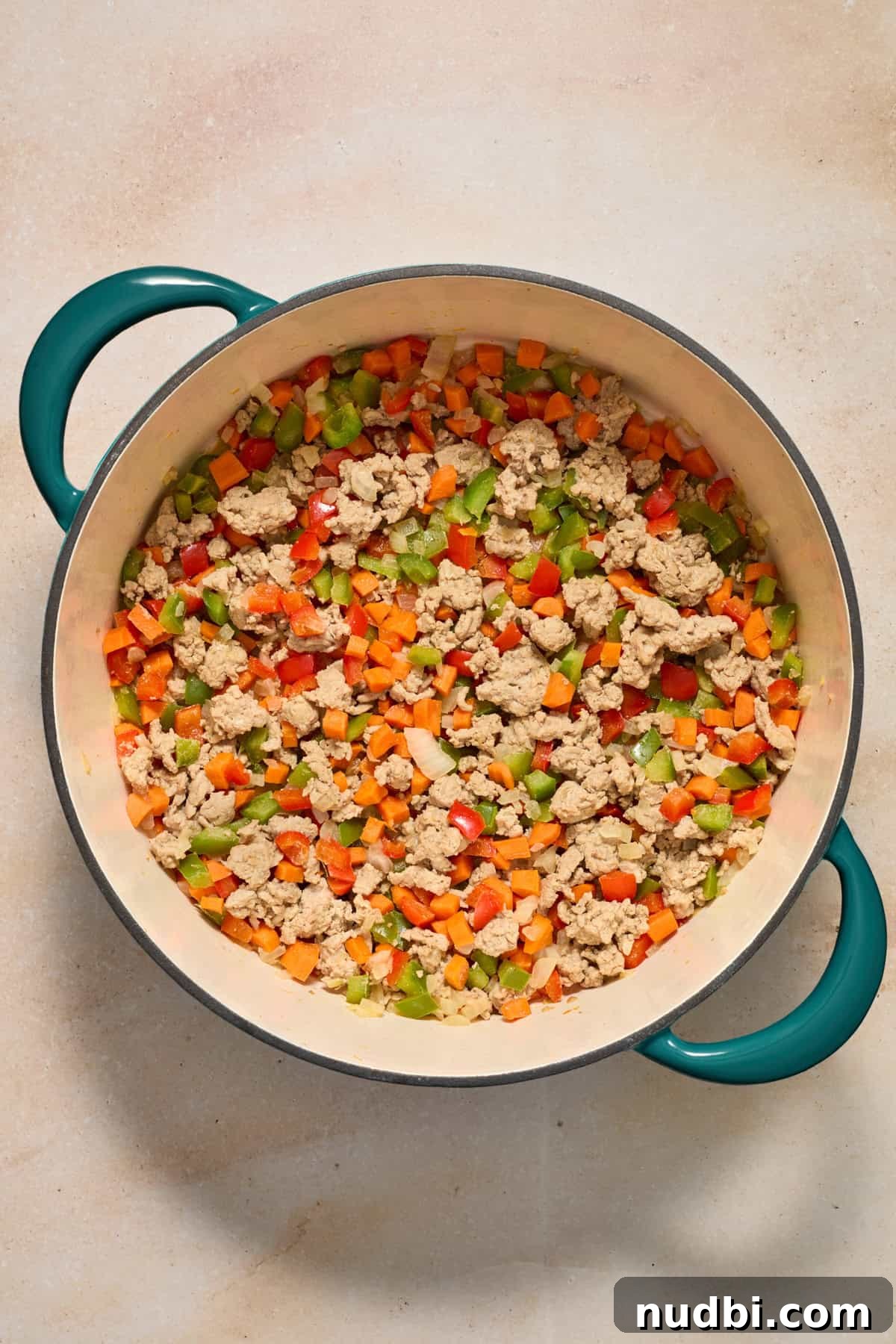 Savory Ground Turkey Spaghetti Sauce Recipe 7 Browned ground turkey in pot with peppers and carrots.