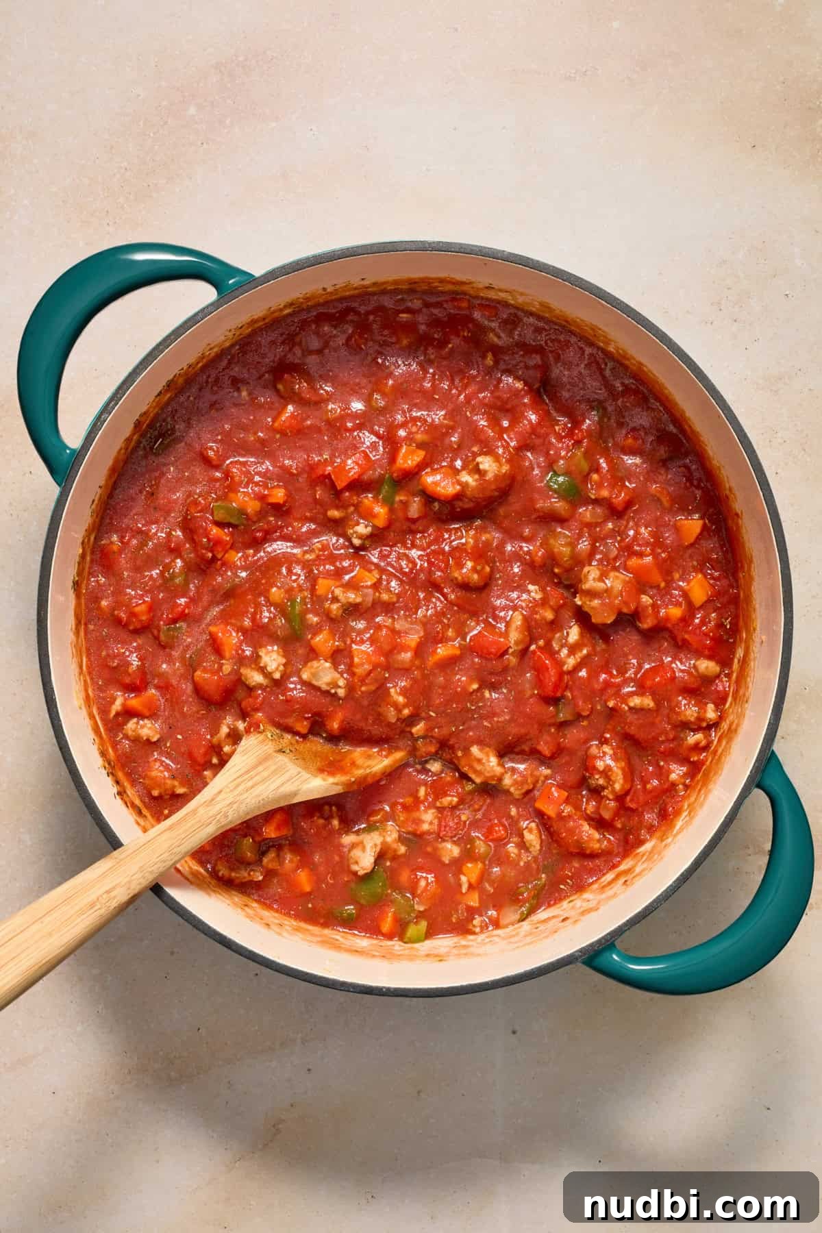Savory Ground Turkey Spaghetti Sauce Recipe 9 Ground turkey meat sauce in pot with spoon.