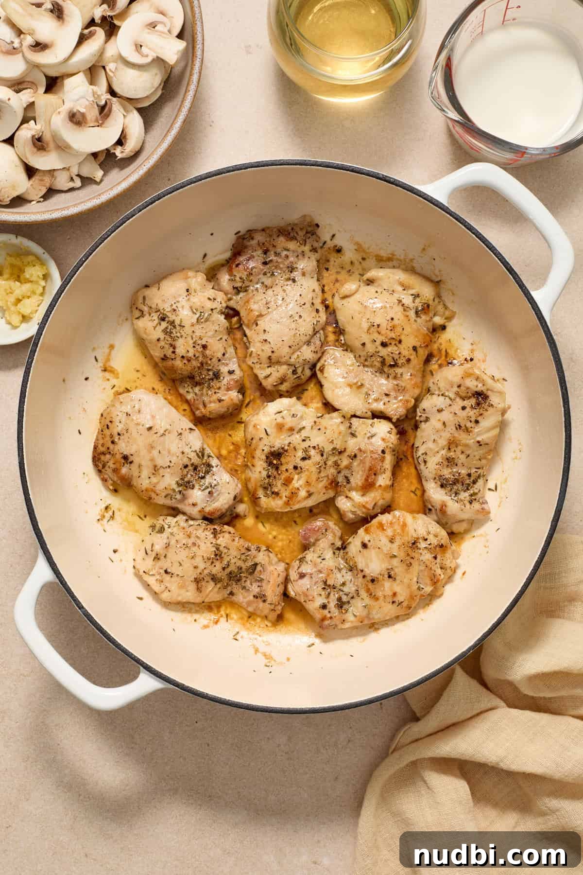 Creamy Mushroom Chicken Thighs with Garlic and Herbs 5 Seared boneless skinless chicken thighs in pan.