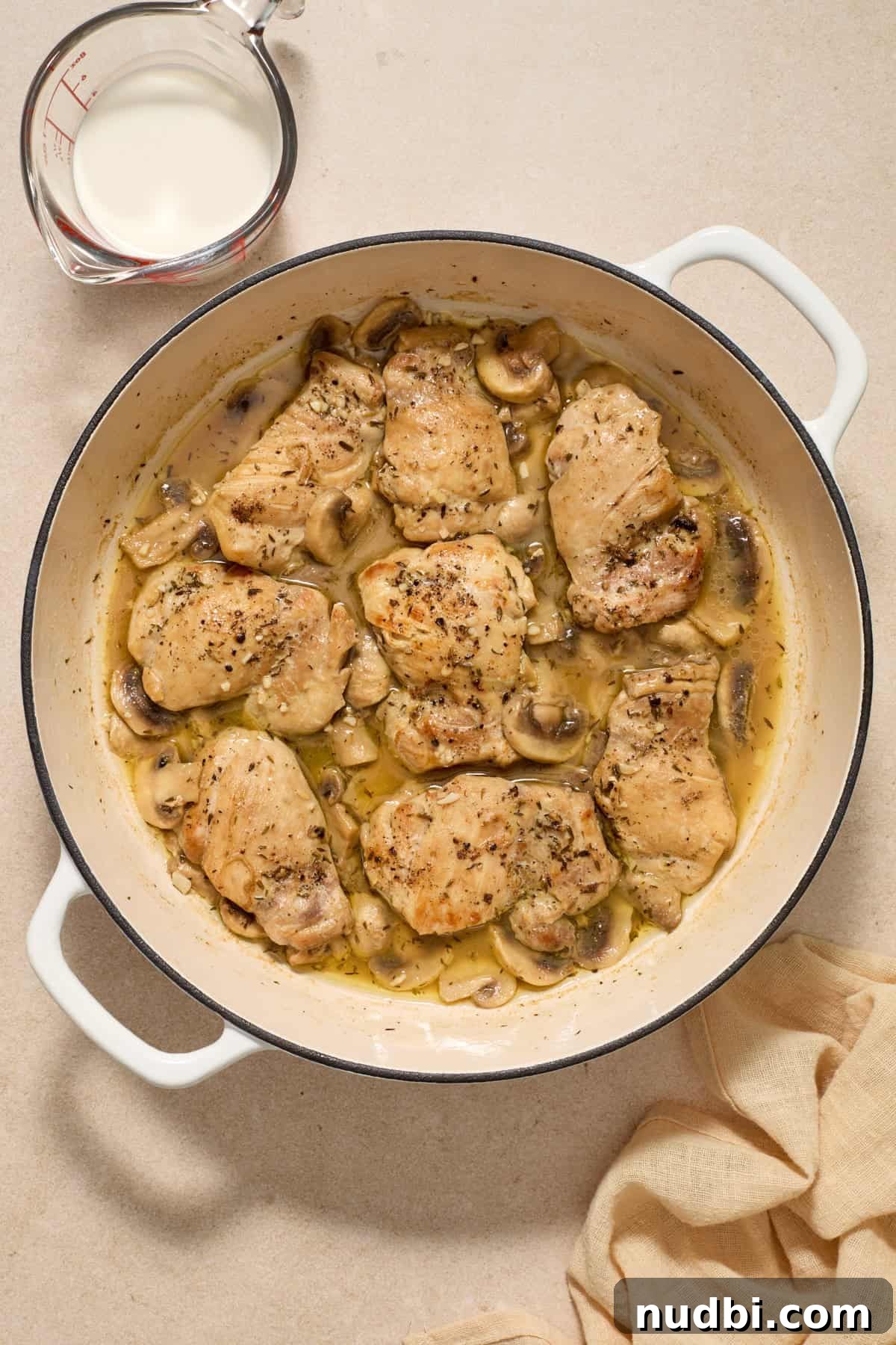 Creamy Mushroom Chicken Thighs with Garlic and Herbs 7 White wine added to skillet with chicken and mushrooms.