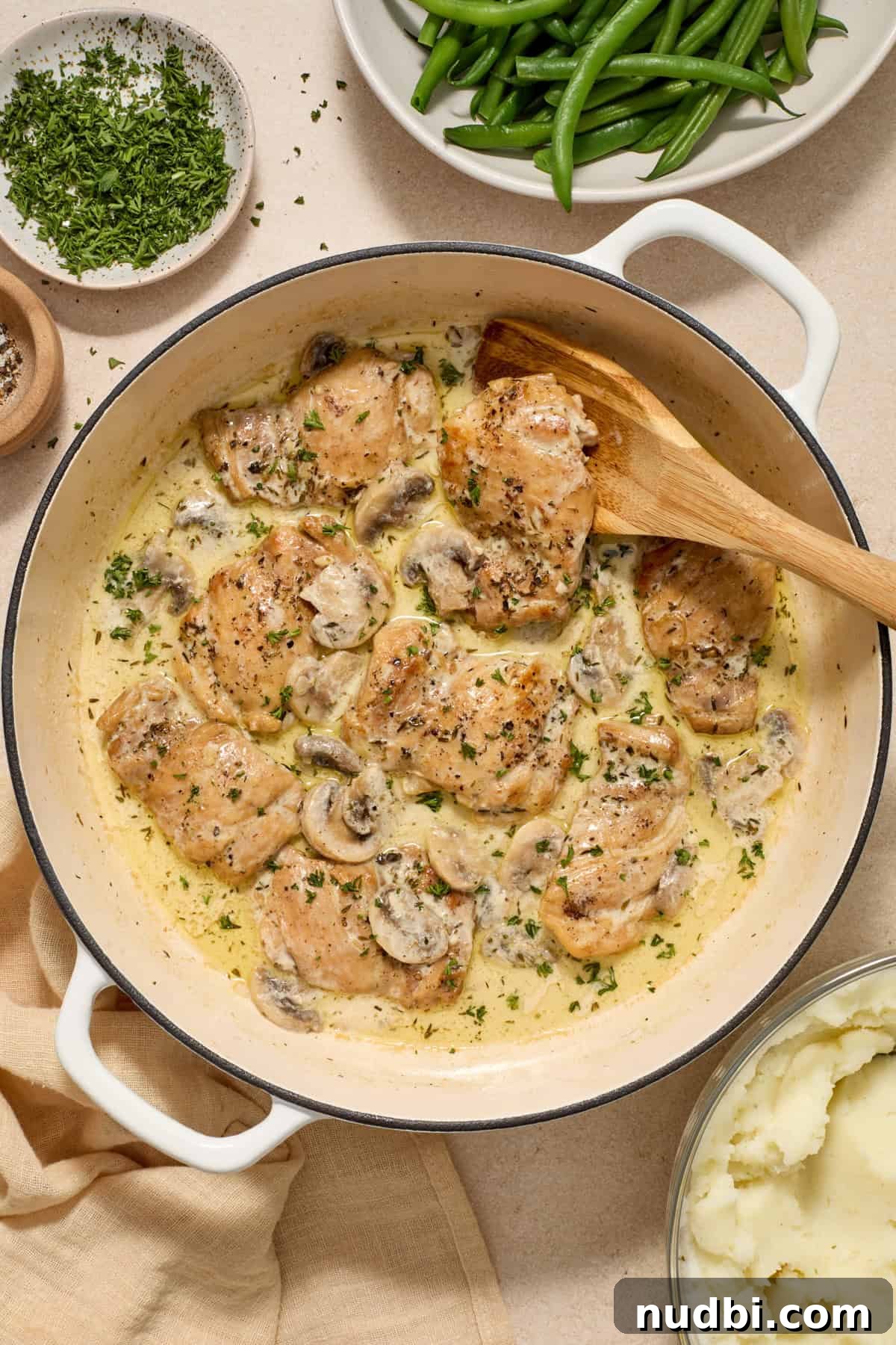 Creamy Mushroom Chicken Thighs with Garlic and Herbs 10 Overhead view of chicken and mushrooms in skillet.