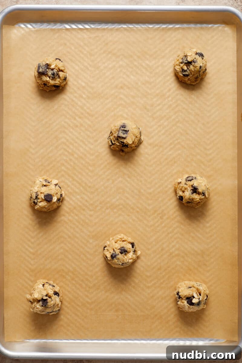 Gluten-Free Almond Flour Oatmeal Chocolate Chip Cookies 9 Oatmeal chip cookie dough rolled into balls and arranged on parchment lined cookie sheet.